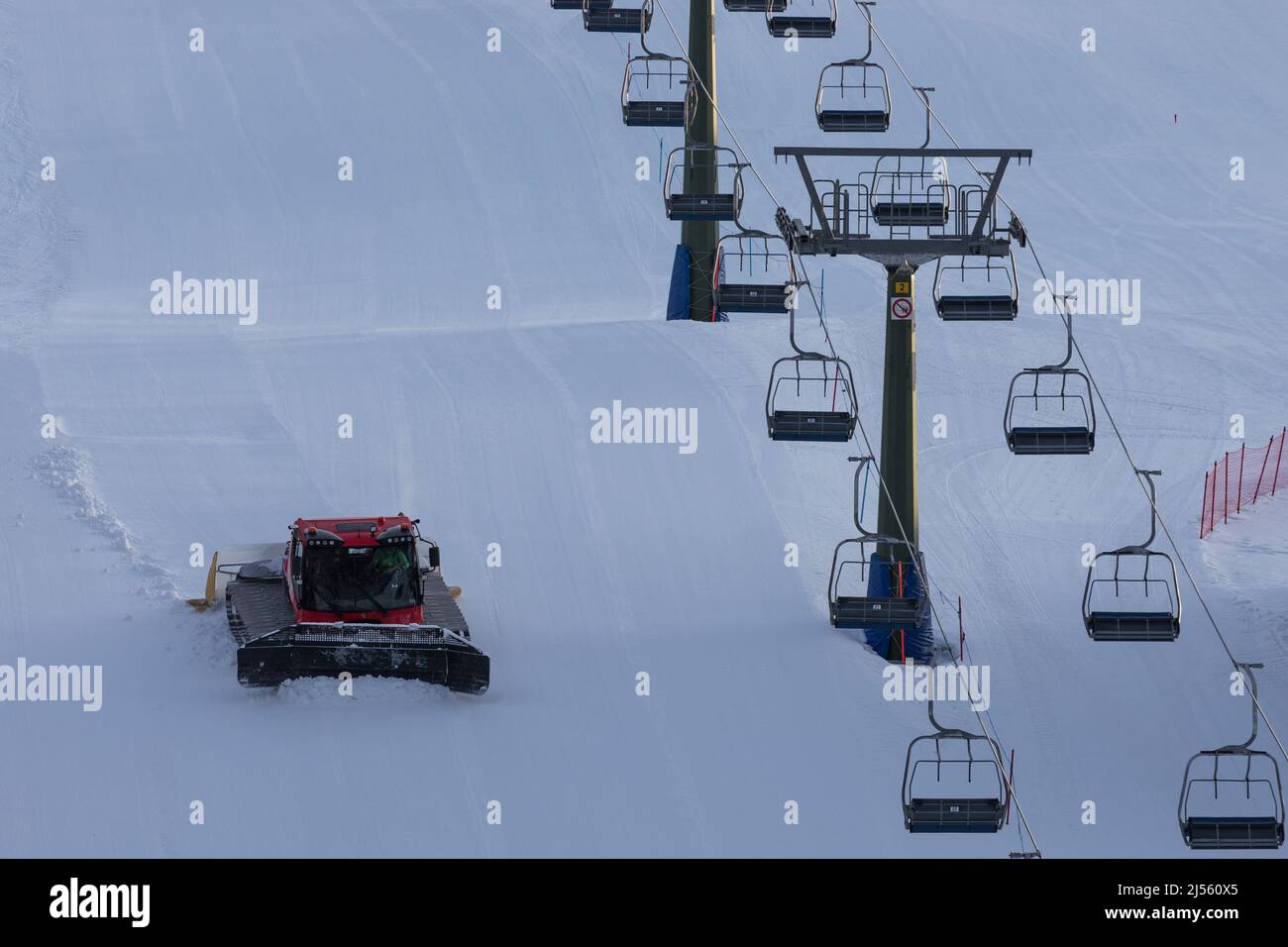 Snow groomer on the ski slope in Dolomites, Italy Stock Photo