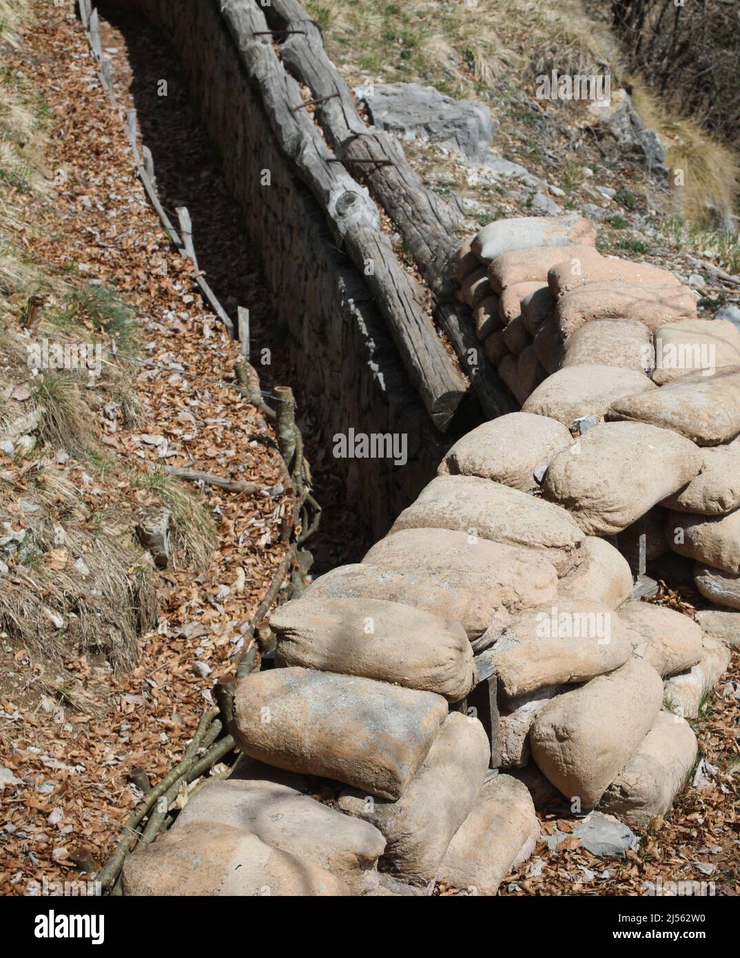 many sandbags to protect the trench dug in the ground by soldiers during the war Stock Photo