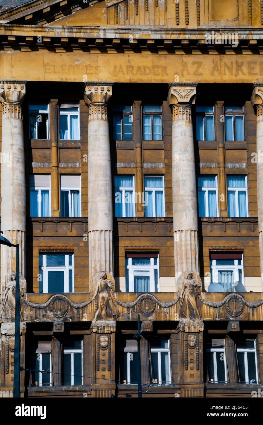 Fluted half columns, bas relief statues and wreaths on a historic