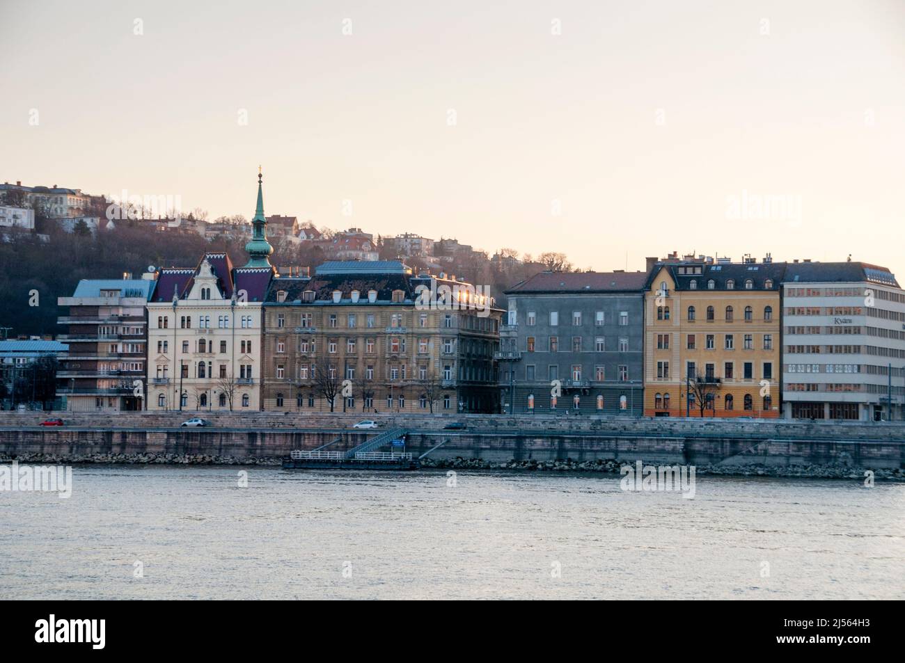 Townhouses on the Danube River in Budapest, Hungary and Baroque spire of St. Catherine of Alexandria. Stock Photo