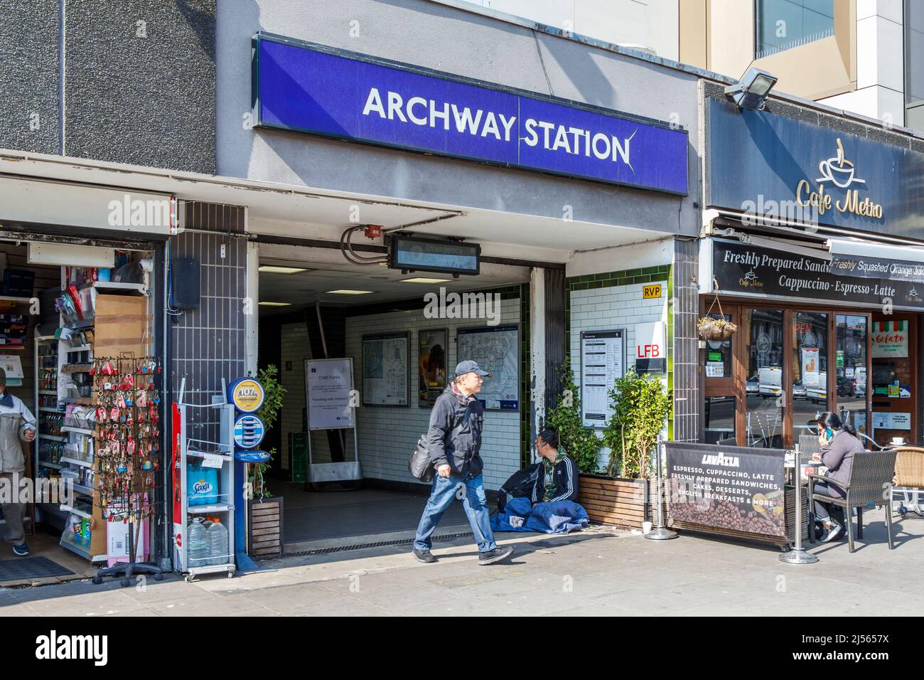 A man exits Archway underground station onto Junction Road in North Islington, London, UK Stock Photo