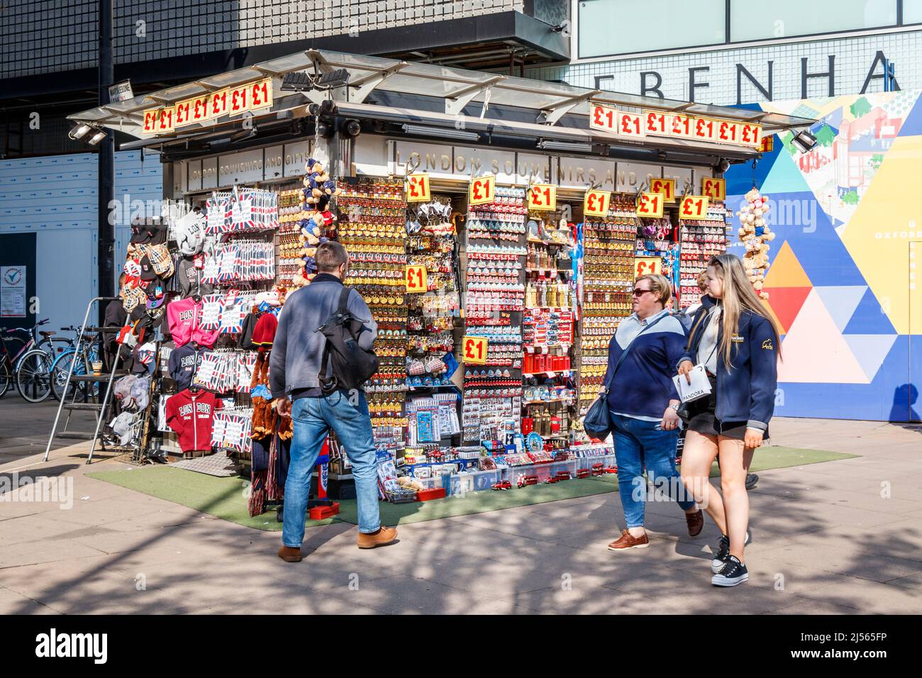 Shoppers walking past a kiosk selling £1 novelty souvenir items in Oxford Street, London, UK Stock Photo