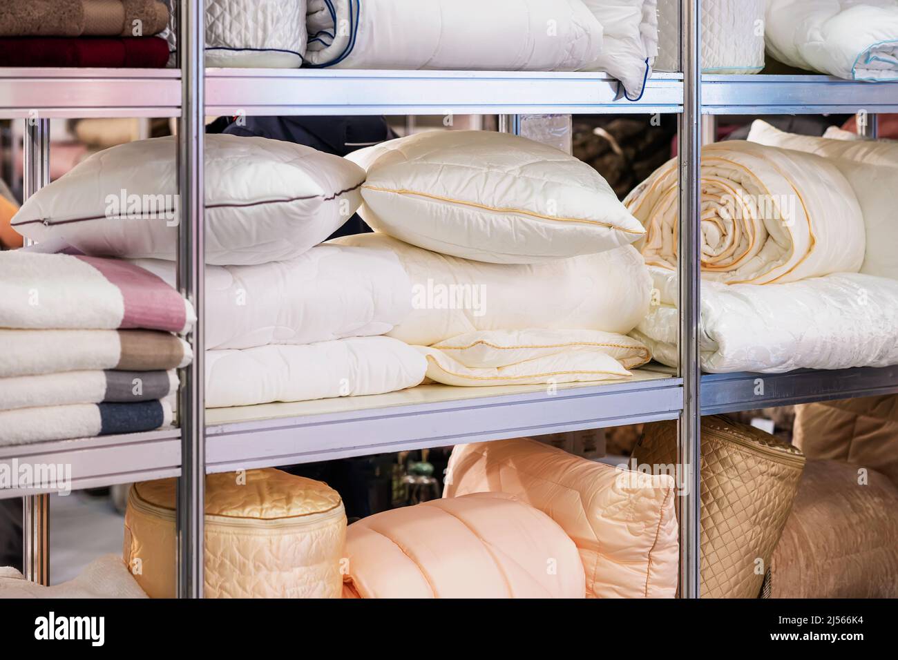 Close-up of store shelf, warehouse with pillows, blankets, bed linen Stock Photo