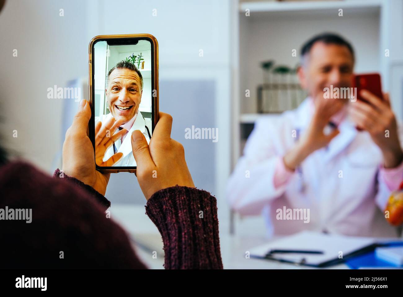 doctor and patient discussing something using smartphones in hospital
