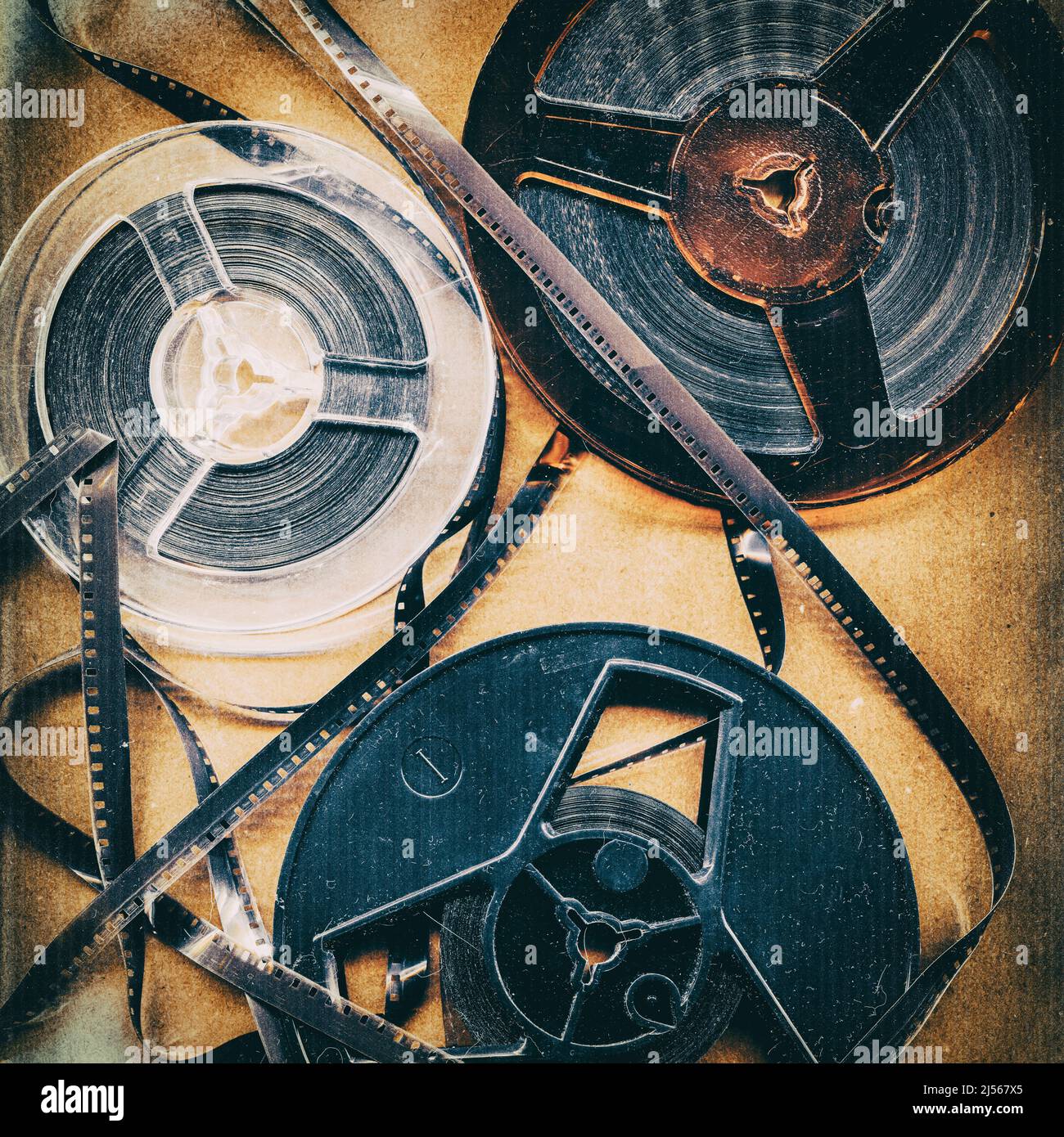 Old style film reels, vintage background with intentional grain, noise,  dust and scratches, top view Stock Photo - Alamy