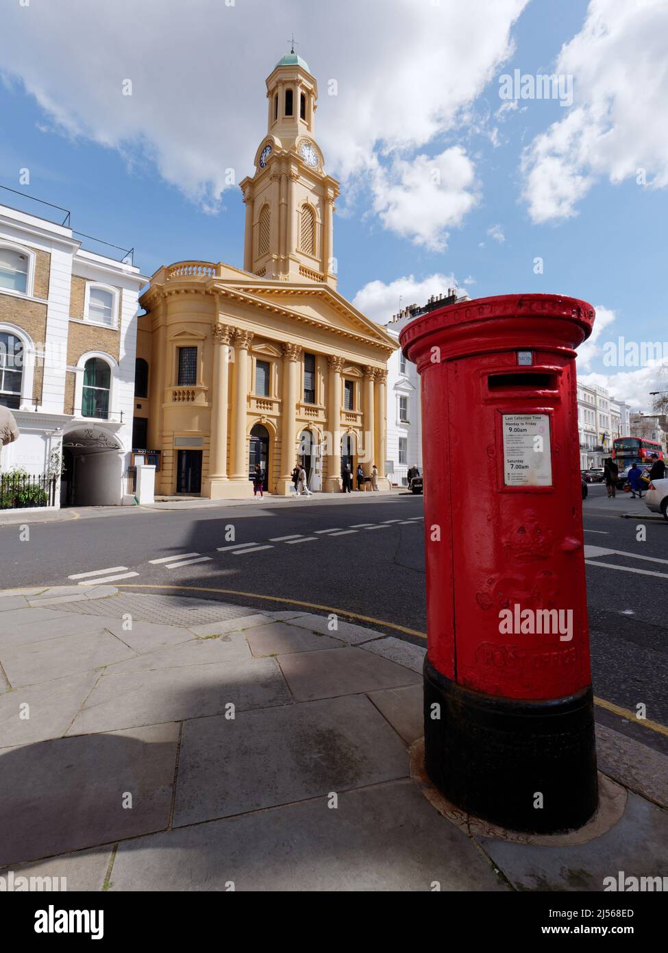 London, Greater London, England, April 09 2022: St Peters Church in Notting Hill with a red post box in the foreground. Stock Photo