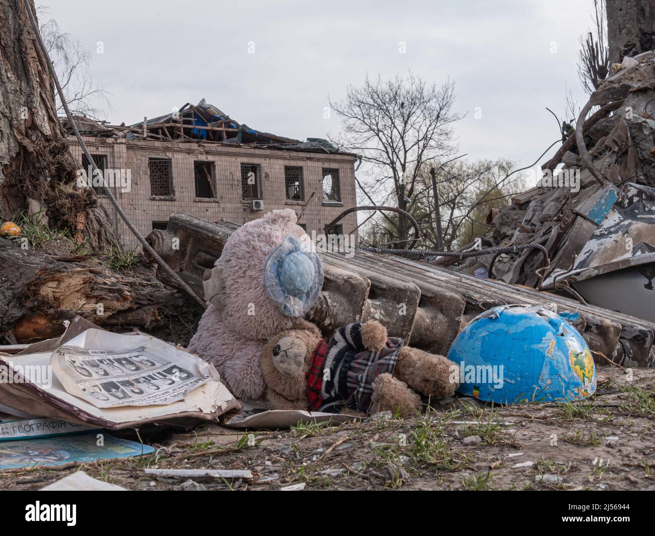 Borodyanka, Ukraine - April 2022: Russia is bombing Ukraine with aviation and ballistic missiles. Consequences of the bombings in Ukrainian cities. Children's toys near bombed-out house. Stock Photo