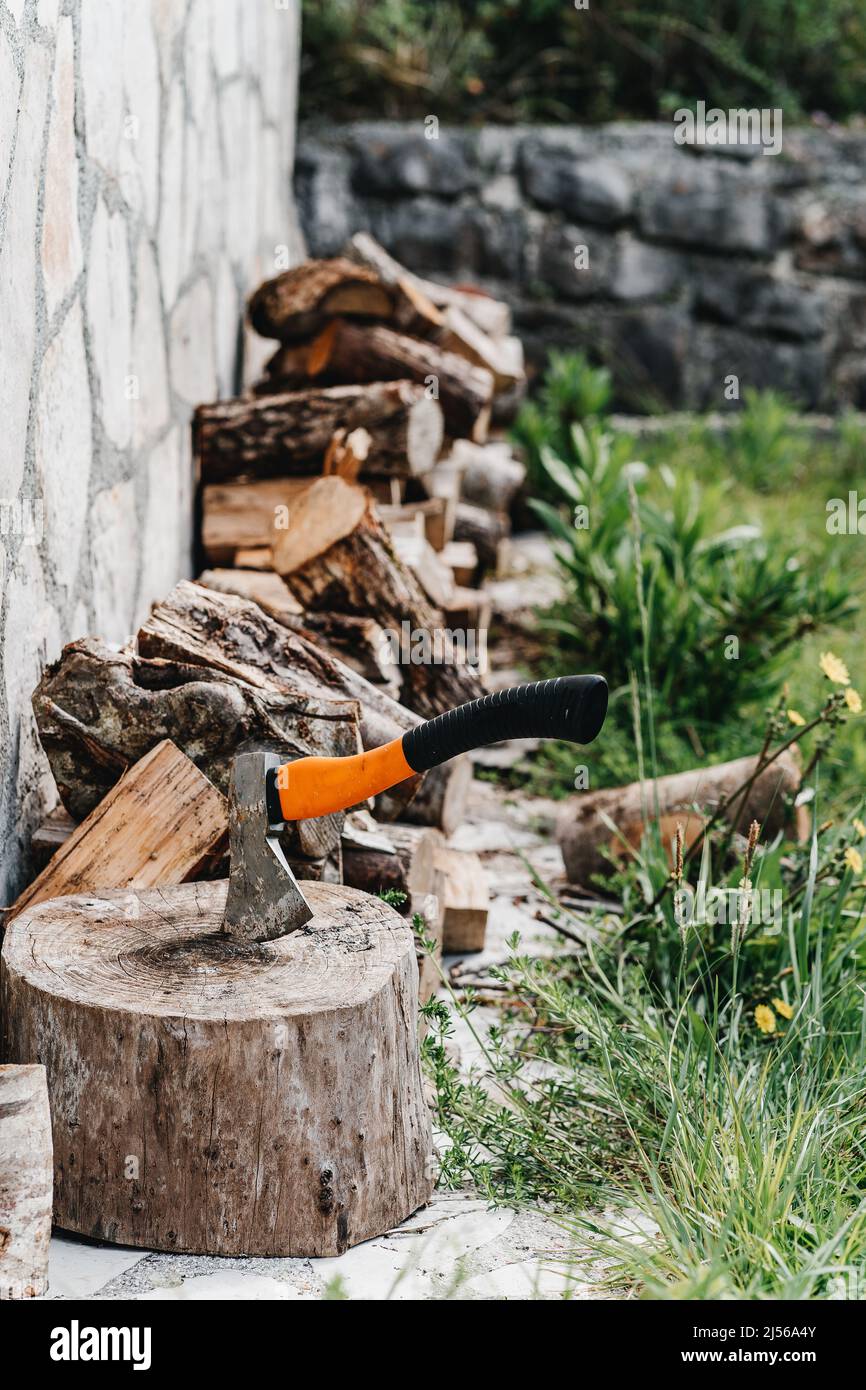 Axe for the crib logs sticks stuck in a tree  Stock Photo