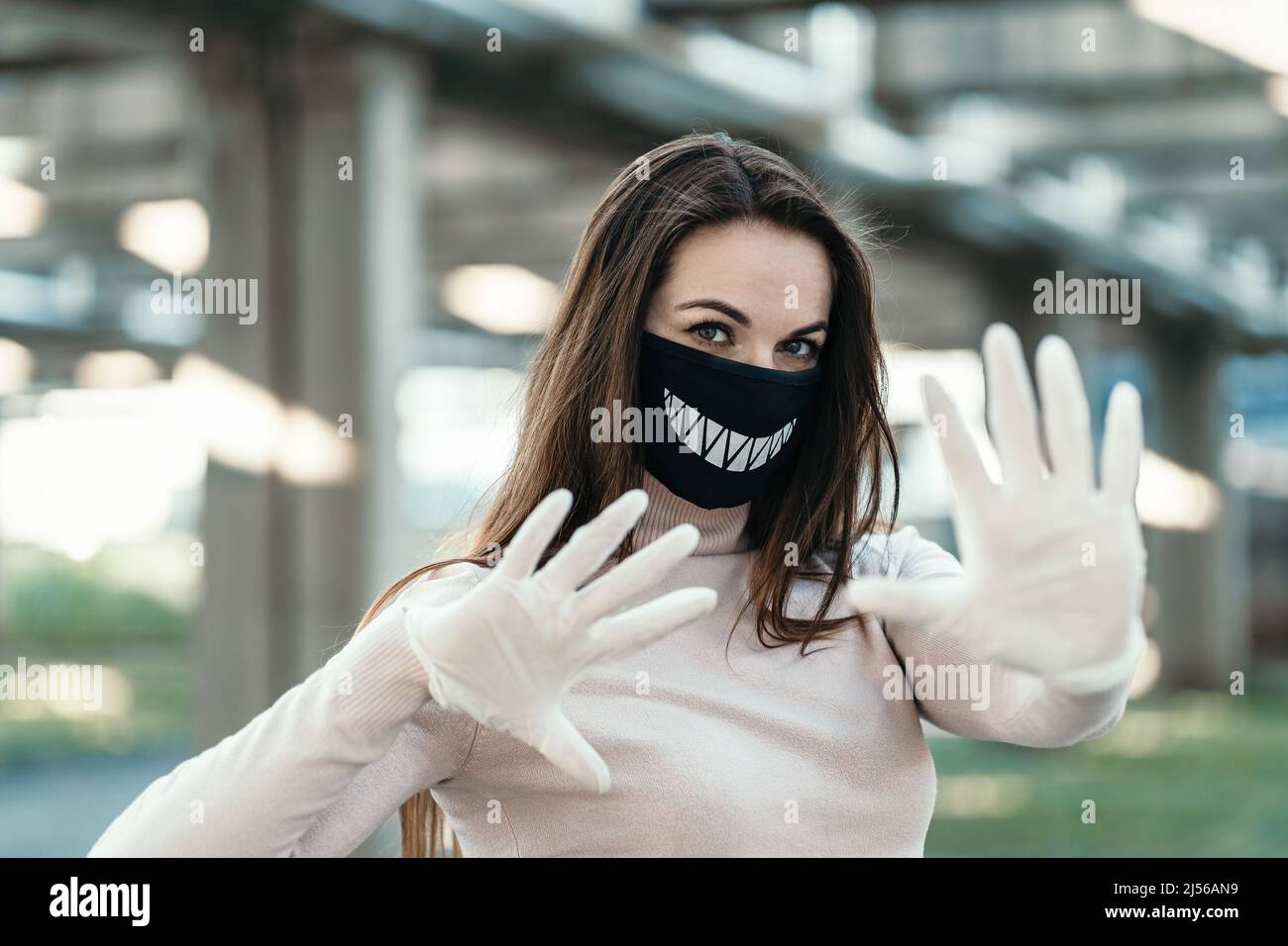 Young girl in funny medical mask and gloves shows stop sign Stock Photo ...