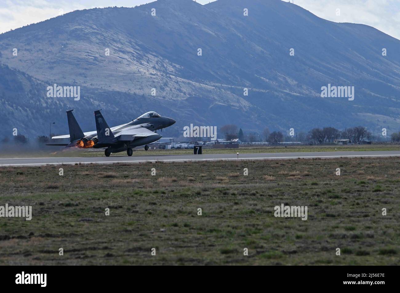 U.S. Air Force F-15C aircraft number 78511, takes to the sky at the foot of Mt. Stukel, in Klamath Falls, Ore. for the last time, heading for its final resting place, the 309th Aerospace Maintenance and Regeneration Group, often called “The Boneyard” at Davis-Monthan Air Force Base, Ariz., March 28, 2022. F-15C models are largely reaching the end of their service life after more than 35 years and will be replaced at the 173rd Fighter Wing with the F-15EX in 2024. (U.S. Air National Guard photo by Master Sgt. Jefferson Thompson) Stock Photo