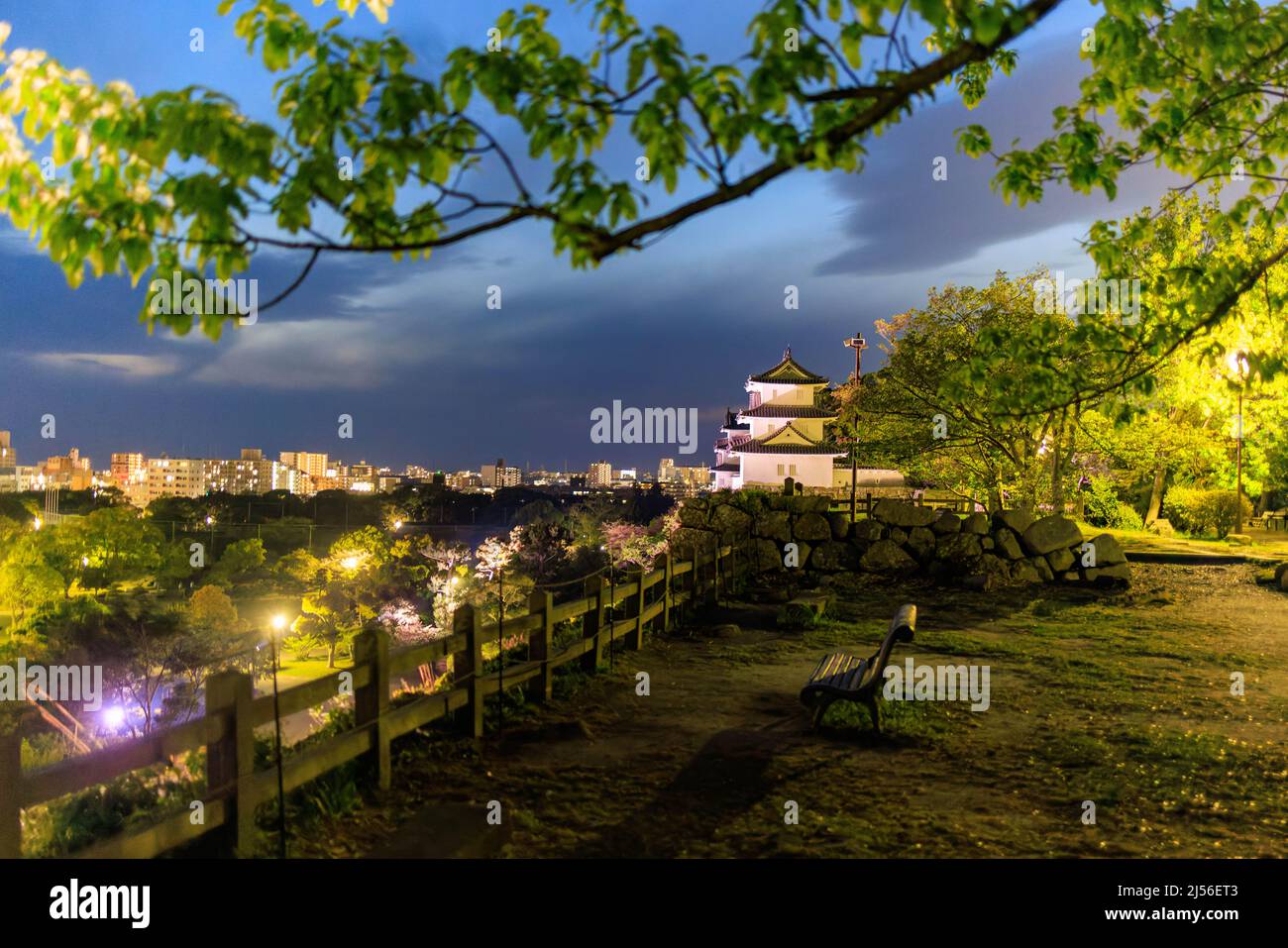 Bench at viewpoint overlooking historic Japanese castle and downtown Akashi  Stock Photo