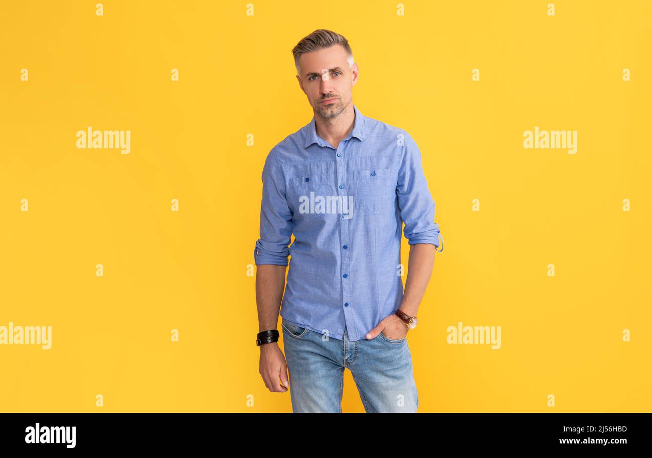 mature man with wrist watch on yellow background, fashion accessory Stock Photo