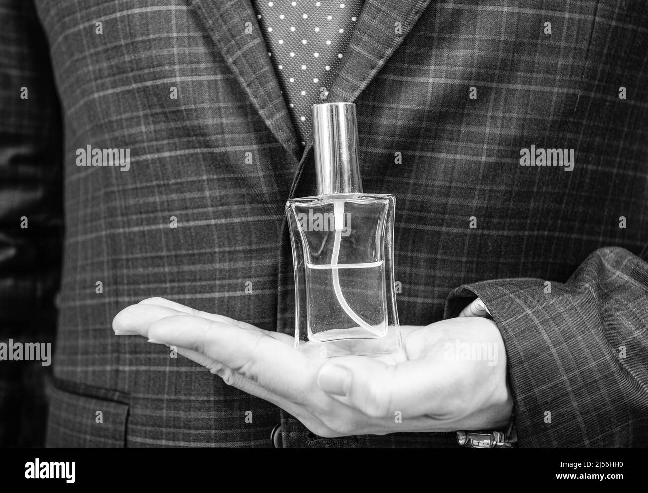 Fresh fragrance for everyday use. Perfume bottle on male hand. Perfume