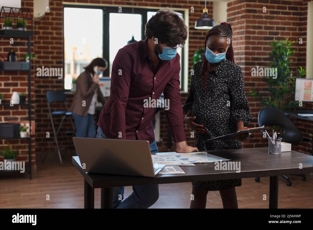Multi ethnic diverse company business employees wearing masks against ...