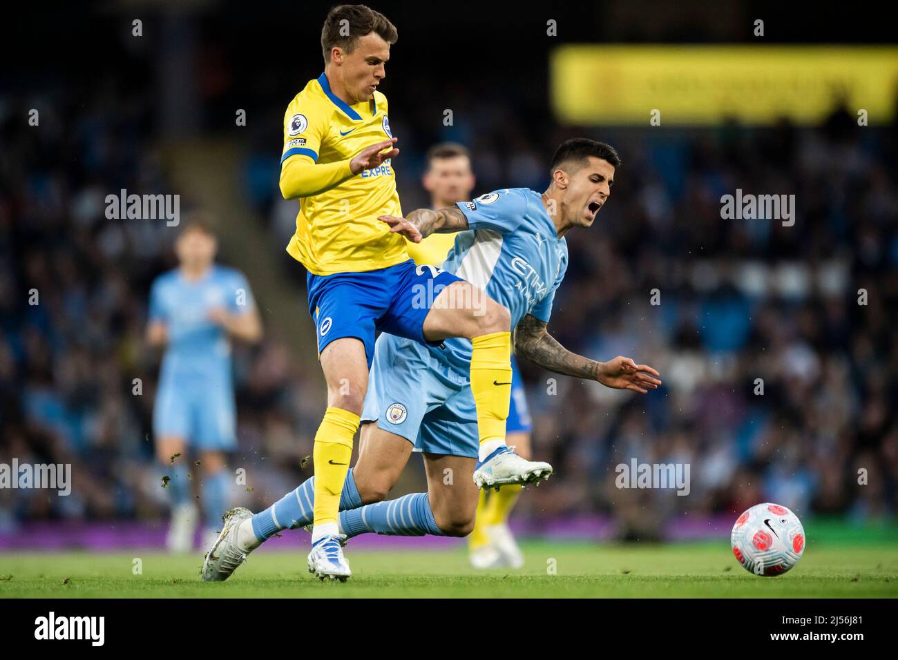 Manchester, UK, 20 April 2022,  Manchester City's Joao Cancelo is tackled by Brighton and Hove Albion's Solly March. Picture date: Thursday April 21, 2022. Photo credit should read:   Anthony Devlin/Alamy Live News/Alamy Live News Stock Photo