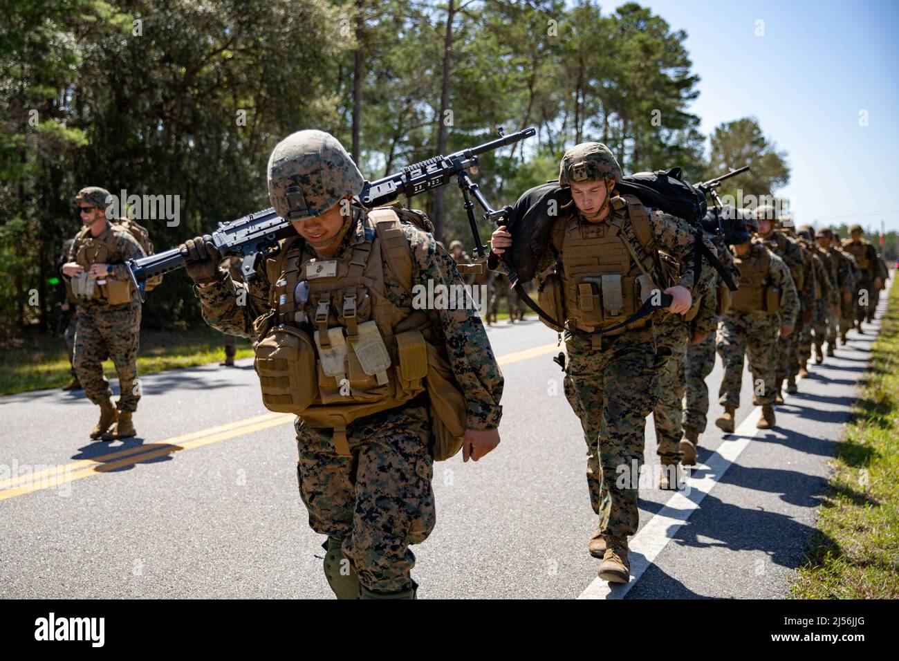 Camp Blanding, Florida, USA. 28th Mar, 2022. U.S. Marines with Combat Logistics Regiment 37, 3rd Marine Logistics Group participate in a hike with M240B medium machine guns during exercise Atlantic Dragon on Camp Blanding, Florida, United States, March 28, 2022. Atlantic Dragon is a force generation exercise pushing CLR-37 as an arrival assembly operations group to provide tactical logistics support to III Marine Expeditionary Force. The exercise consists of an experimental maritime prepositioned force's offload tactics of military equipment that supports field exercise training to i Stock Photo