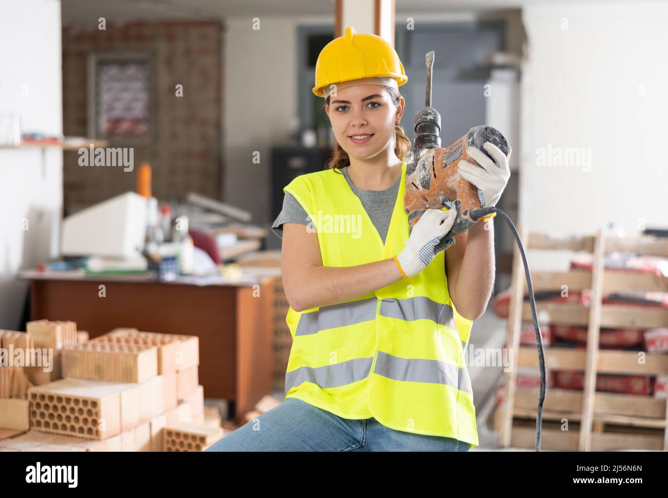 Female builder posing on indoor construction site Stock Photo