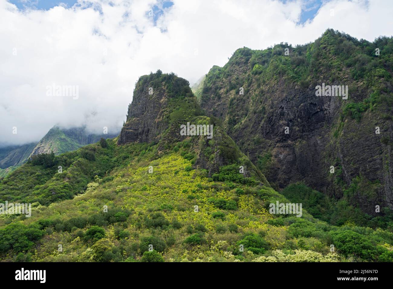 mountainous and lush iao valley state park amidst clouds in west maui hawaii Stock Photo