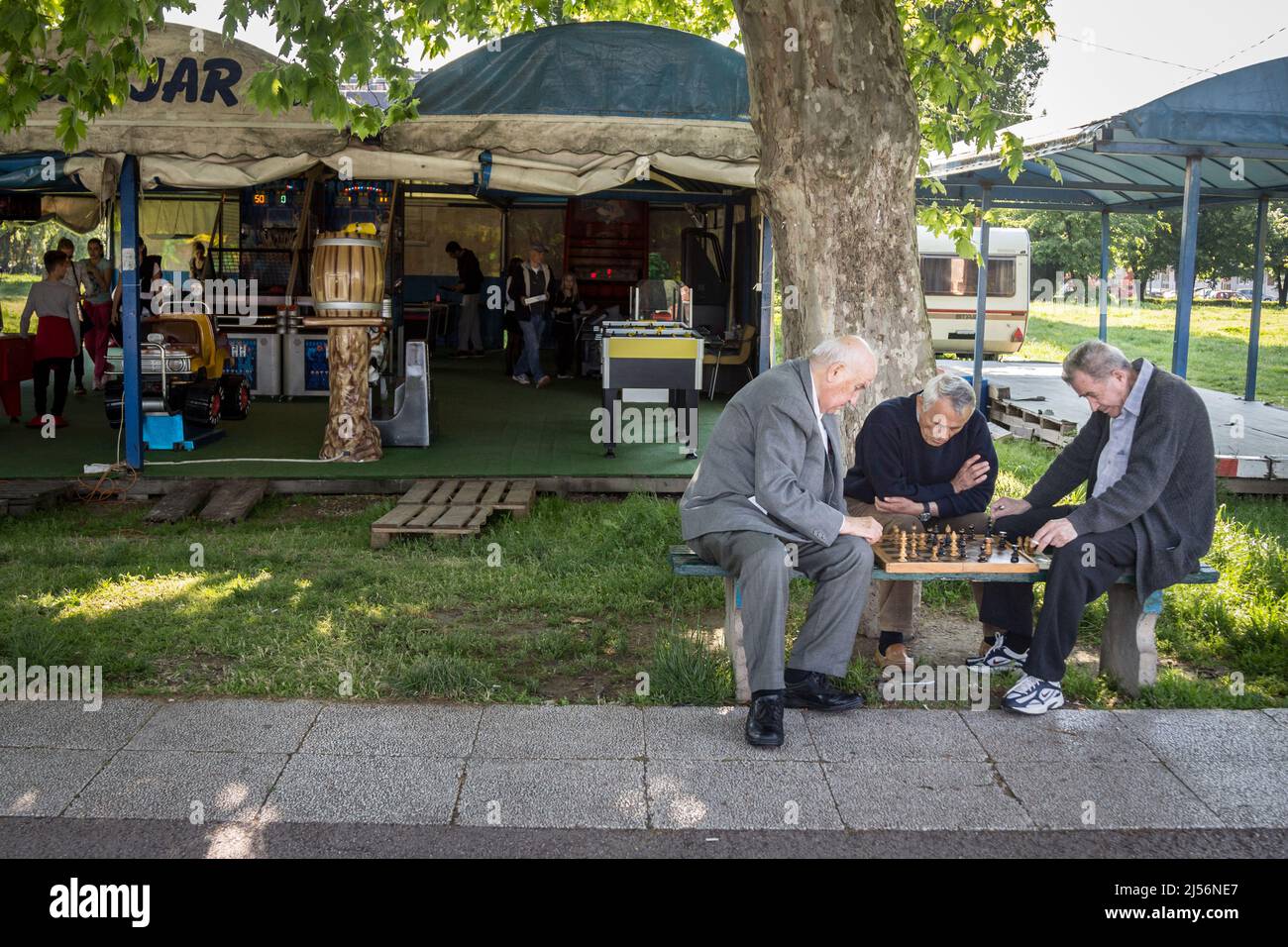 Picture of aged men playing chess in one of Belgrade's main parks, Zemun, which is as well the main touristic spot of the capital city of Serbia Stock Photo