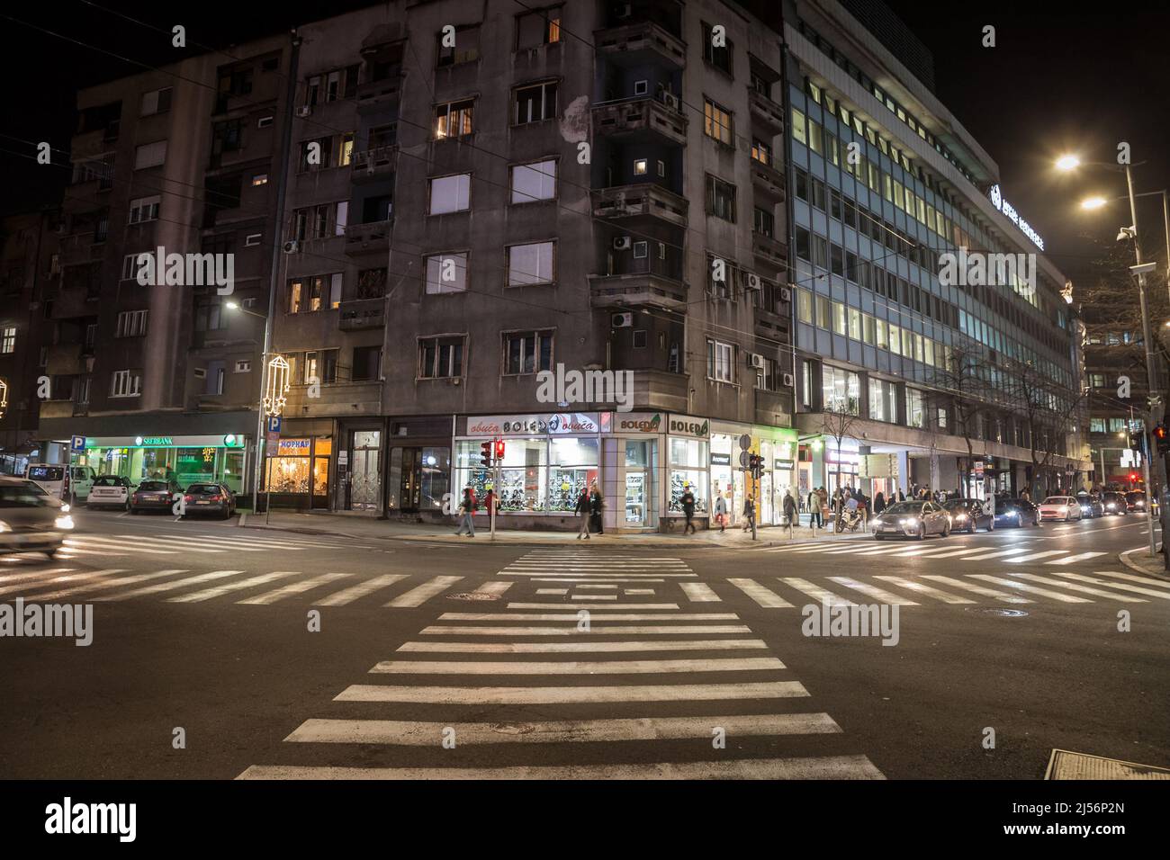 Picture of a zebra crossing in the city center of Belgrade, Serbia, at night, with cars ready to cross the area. It's located in Stari Grad, the busie Stock Photo