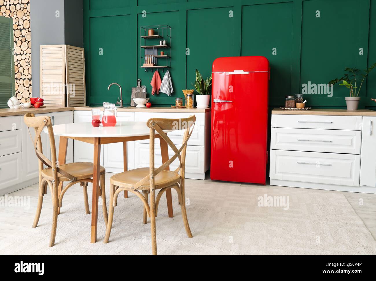 Interior of modern kitchen with dining table, stylish refrigerator and ...
