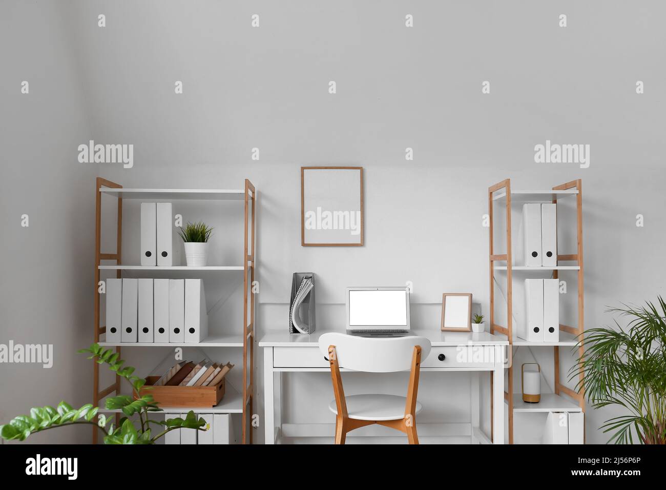 Modern workplace and shelf units in office interior Stock Photo Alamy