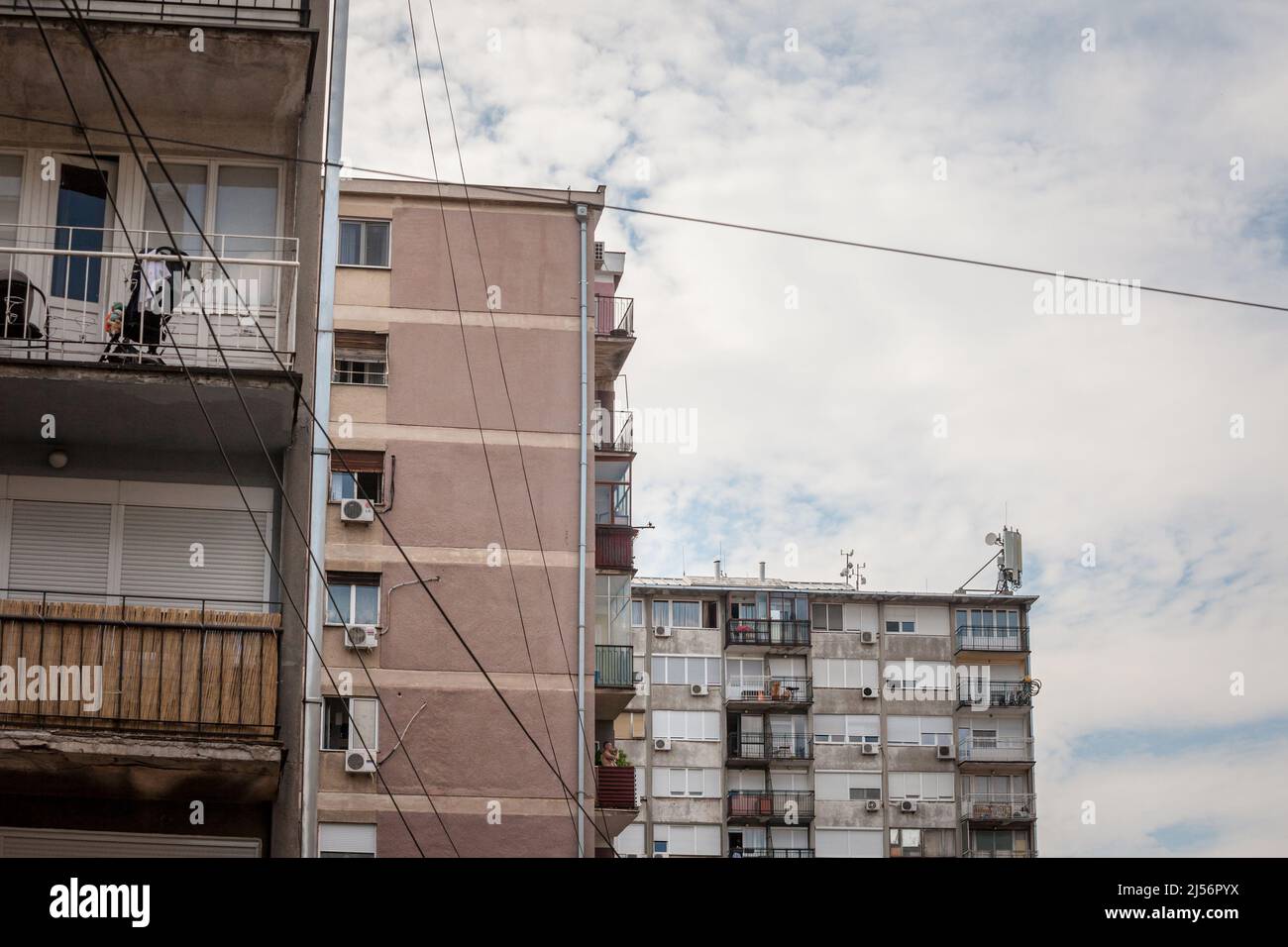 Picture of Eastern European towers in Belgrade, Serbia, in poor condition with concrete falling down and old AC units. These buildings are a symbol of Stock Photo