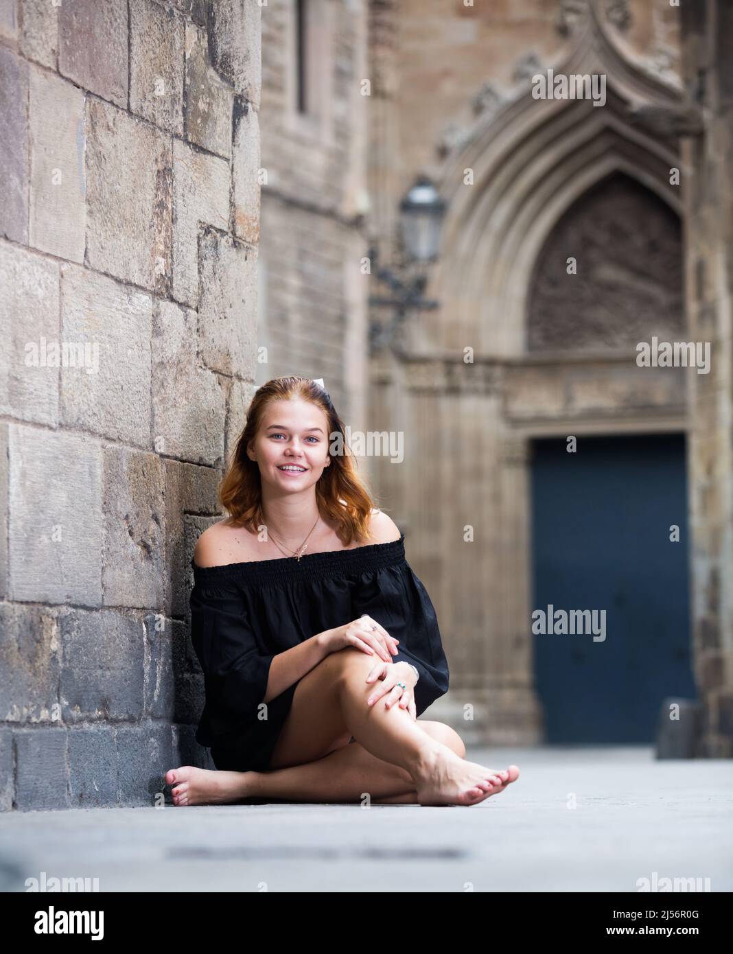Positive Girl Sitting Barefoot Near The Stone Wall Stock Photo Alamy positive-girl-sitting-barefoot-near-the-stone-wall-stock-photo-alamy