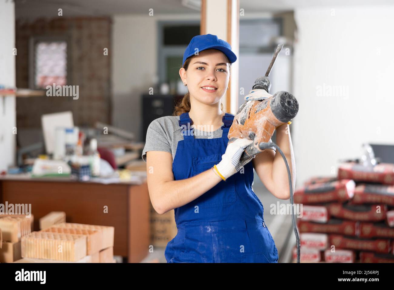 Female worker posing on indoor construction site Stock Photo