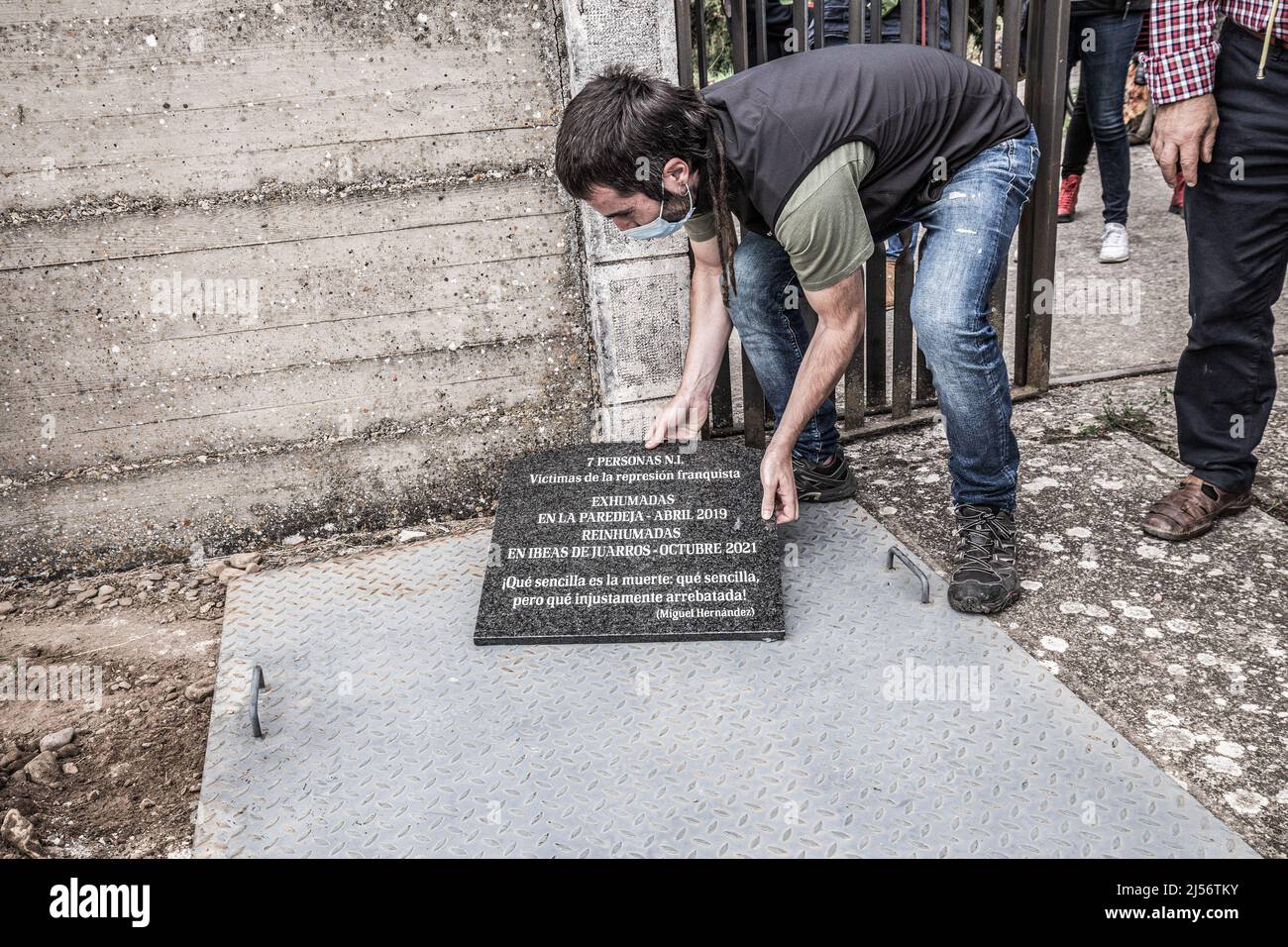 Burgos, Spain. 02nd Oct, 2021. A man places a plaque next to a text by Miguel Hernandez to honor the memory of those killed under Franco. The Provincial Coordinator for the Recovery of the Historical Memory of Burgos organizes an act of reburial and homage to the 7 bodies found in a pit of La Paredeja, in Ibeas de Juarros. (Photo by Jorge Contreras Soto/SOPA Images/Sipa USA) Credit: Sipa USA/Alamy Live News Stock Photo