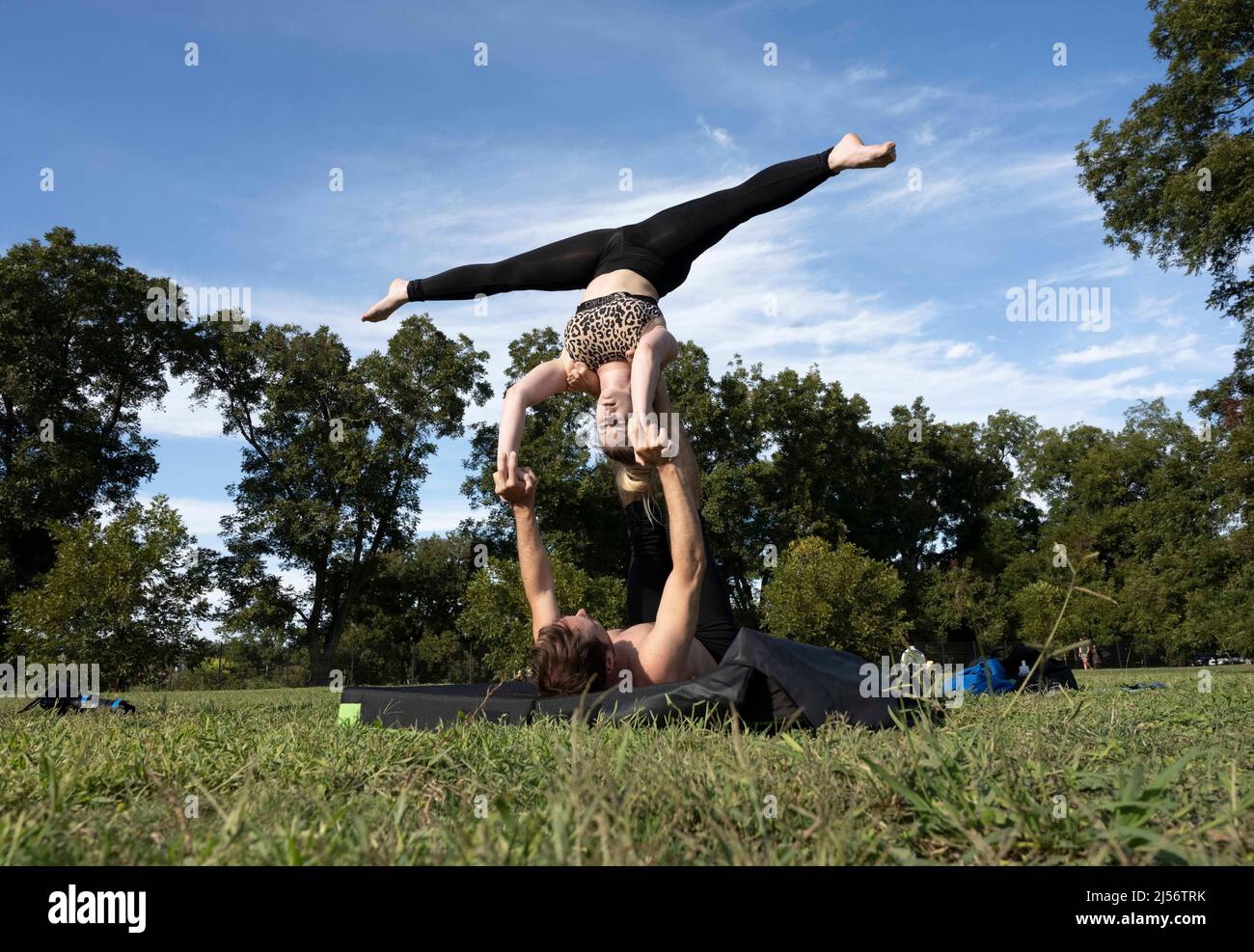 Austin, Texas, USA. 17th Oct, 2021. Practicing yoga poses in south Zilker Park are residents Shelby Higley (top) and friend Bevin Bryson (bottom) (Credit Image: © Bob Daemmrich/ZUMA Press Wire Service) Stock Photo