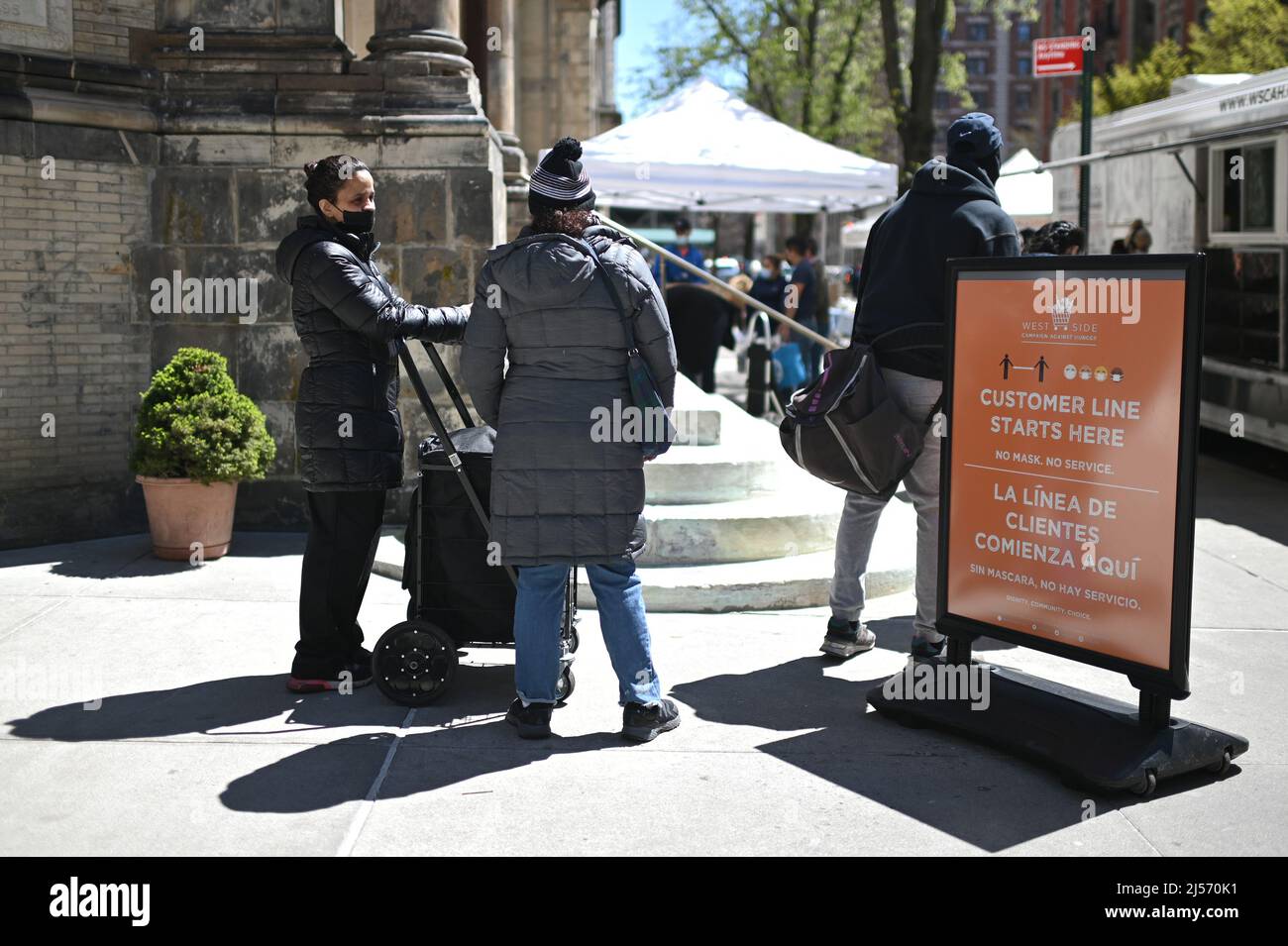 New York, USA. 20th Apr, 2022. People wait to register to receive donated food from the West Side Campaign Against Hunger outdoor mobile food pantry market outside of St. Paul & St. Andrew United Methodist Church, New York, NY, April 20, 2022. (Photo by Anthony Behar/Sipa USA) Credit: Sipa USA/Alamy Live News Stock Photo