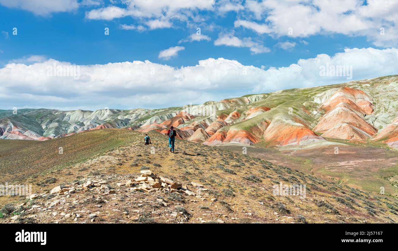 Hikers climb a high hill in a desert area Stock Photo - Alamy