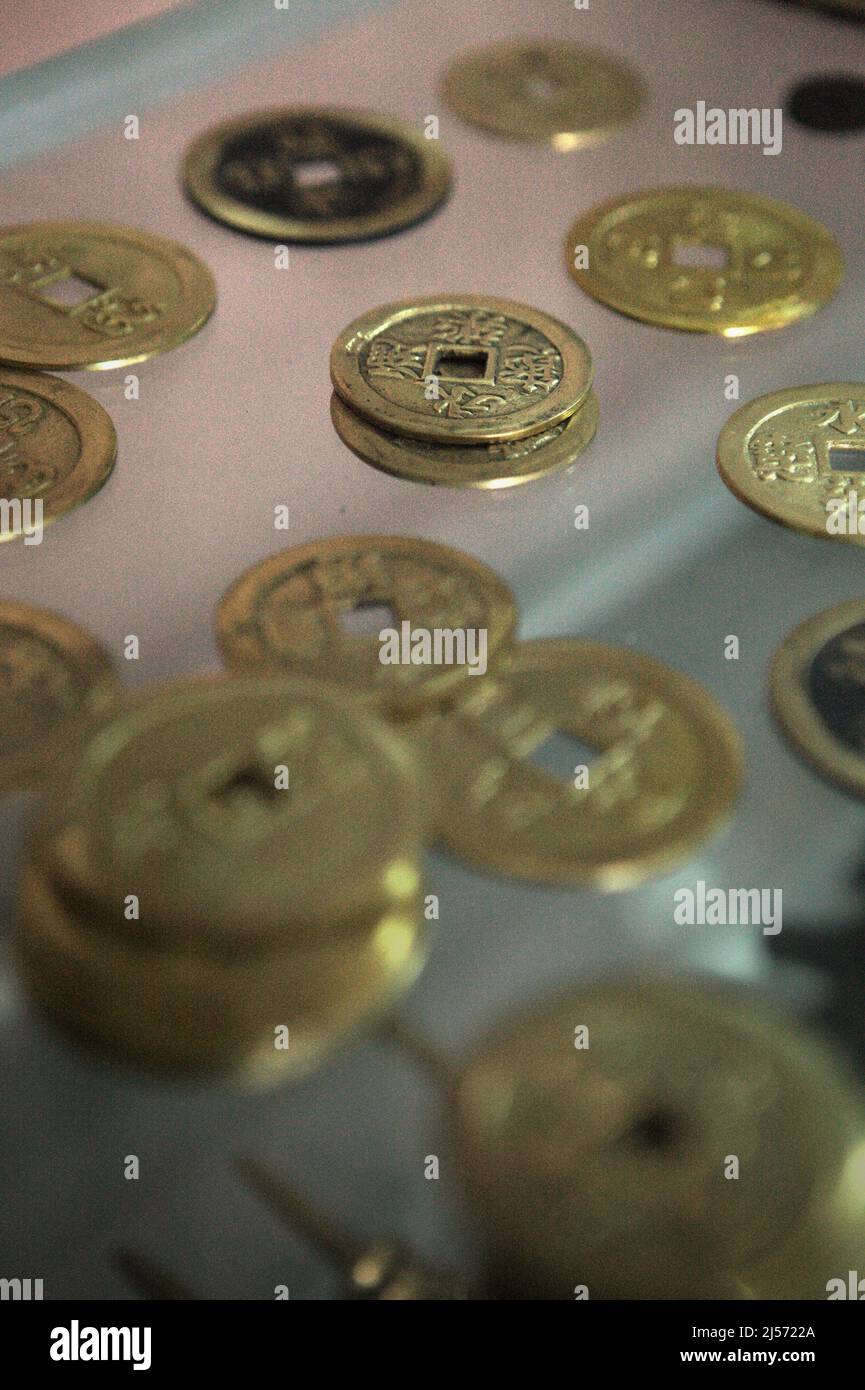 Traditional Balinese coins with hollow known as 'pis bolong/jinah bolong/uang kepeng' in Kamasan village, Klungkung, Bali, Indonesia. Used in transactions across Bali in the past, the coins are nowadays essential in traditional religious rituals in the 'Island of Gods'. Stock Photo