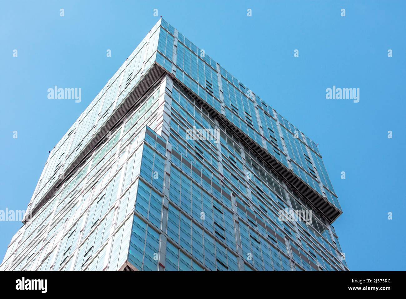 Glass facades of a window of financial skyscrapers, a corner of a building close-up Stock Photo