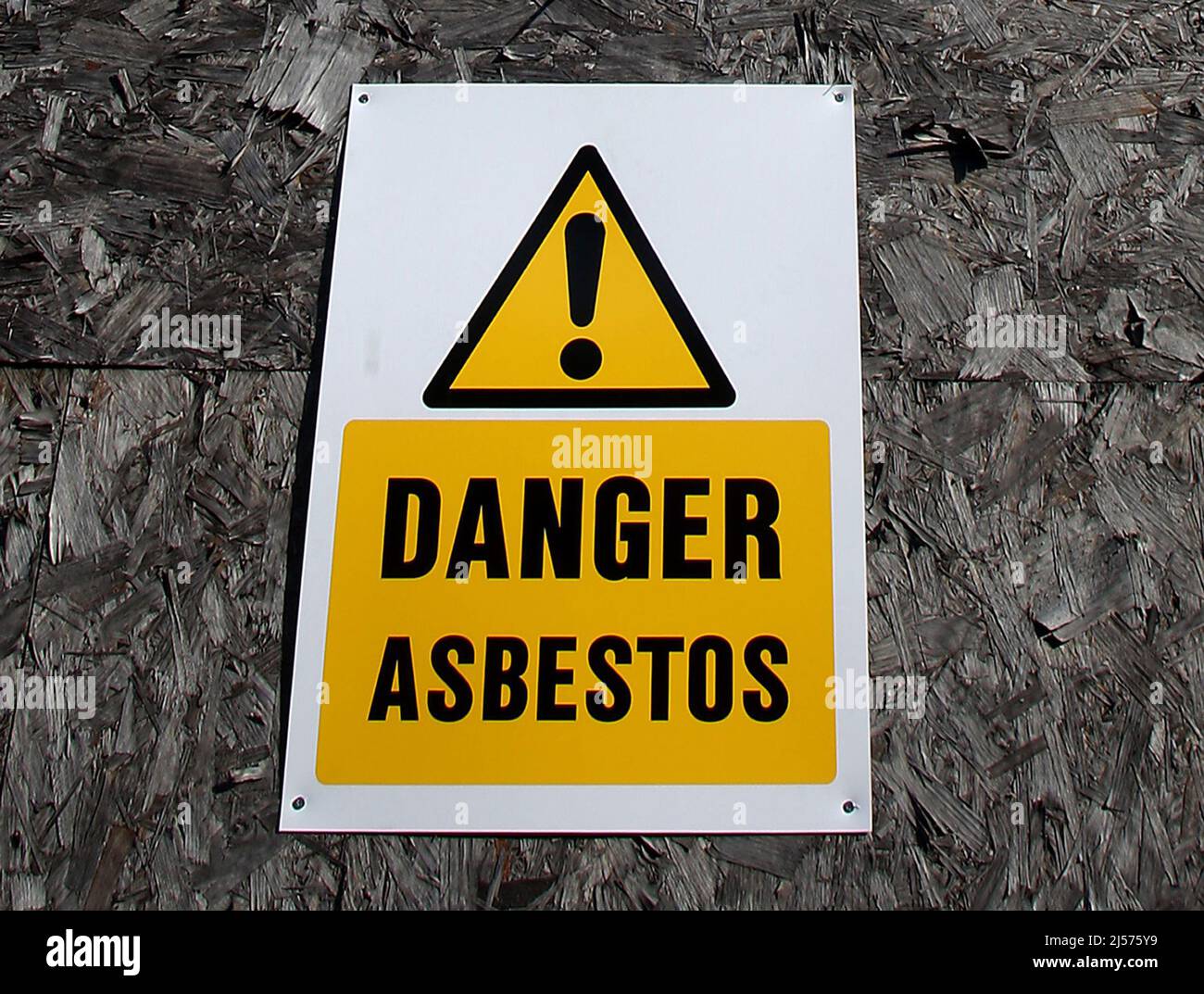 File photo dated 8/2/2009 of an asbestos warning sign. Ministers should set a 40-year deadline for the removal of all remaining asbestos from public and commercial buildings, MPs have said. Issue date: Thursday April 21, 2022. Stock Photo