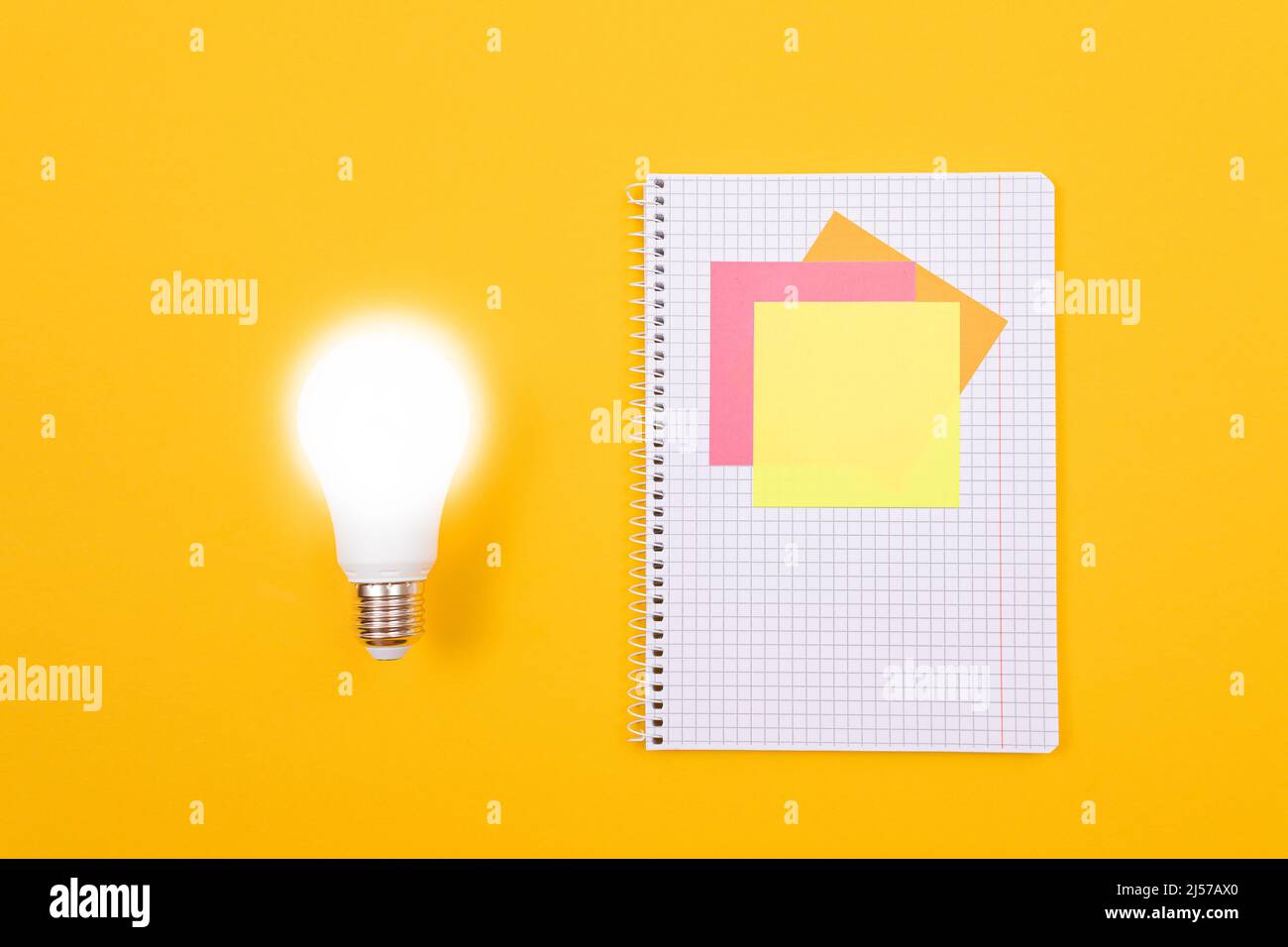 An Idea Concept Glowing Power Saving Lamp and A Notepad with Sticky