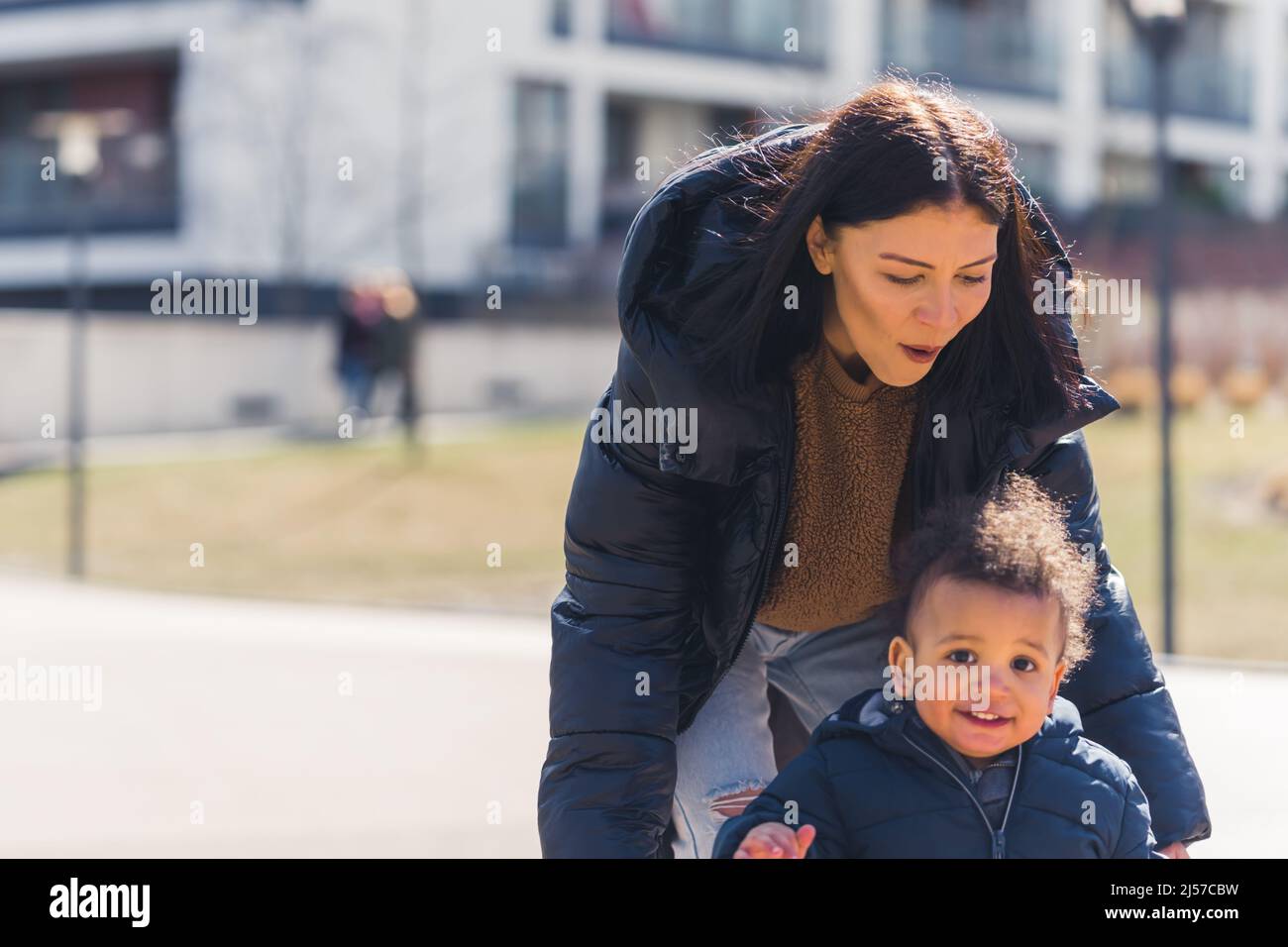 mom rides her son on the playground. High quality photo Stock Photo - Alamy