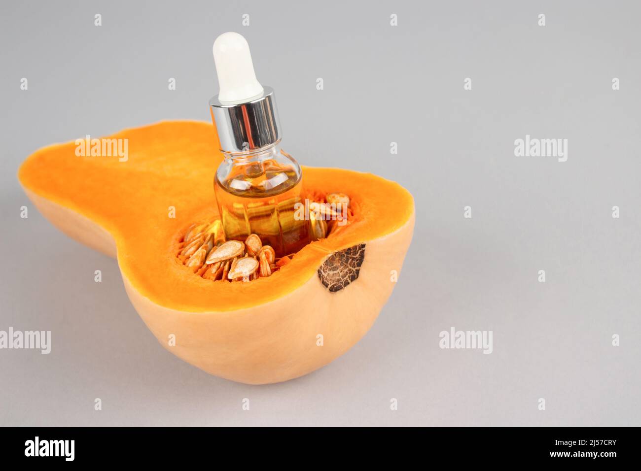 Dropper bottle with natural organic pumpkin seeds cosmetic oil