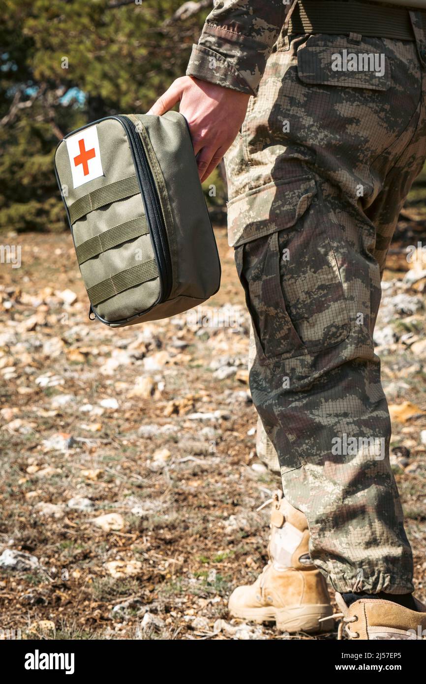 Military army first aid kit. Camouflaged soldier medic. White and red ...