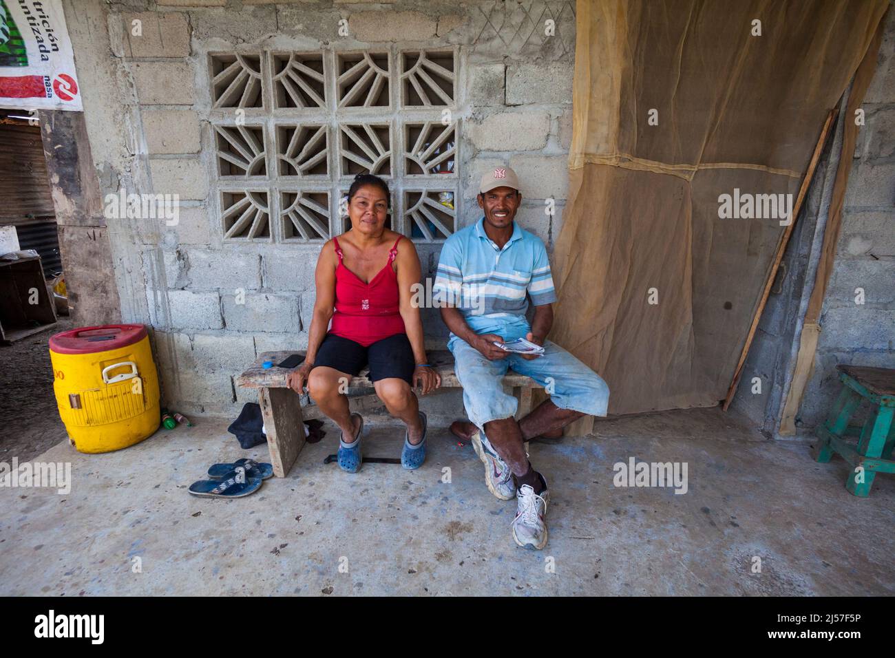 Panamanian man and woman outside their concrete house beside Rio Grande, Cocle province, Republic of Panama, Central America. Stock Photo