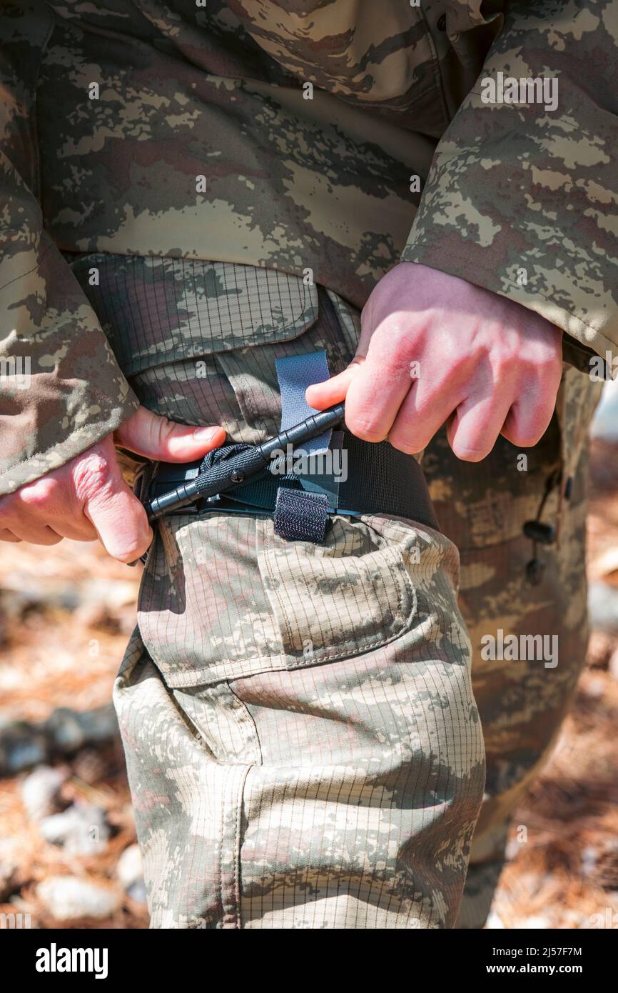 Army soldiers practicing military tourniquet application Stock Photo