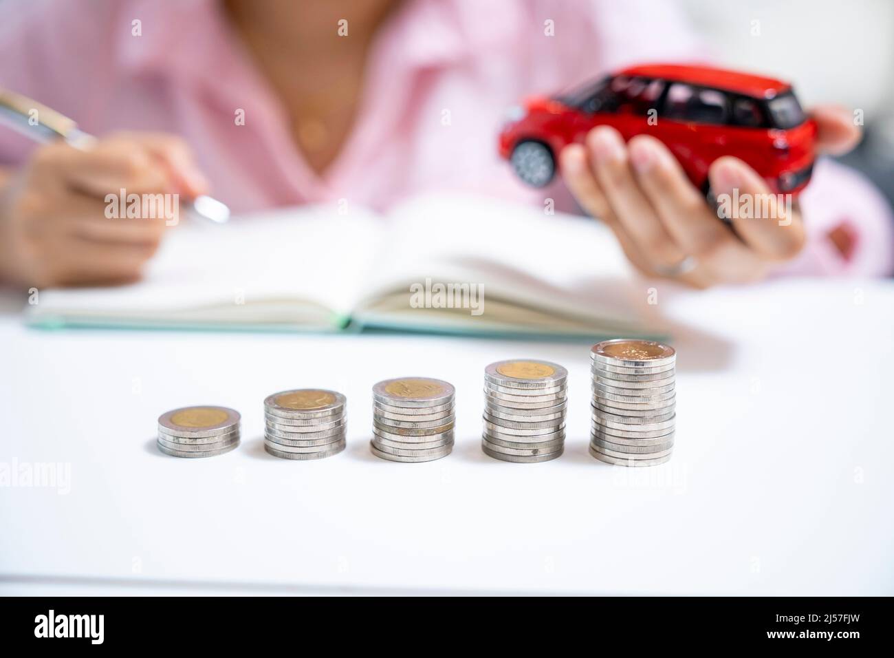 Part of female saving money for buy a car Stock Photo