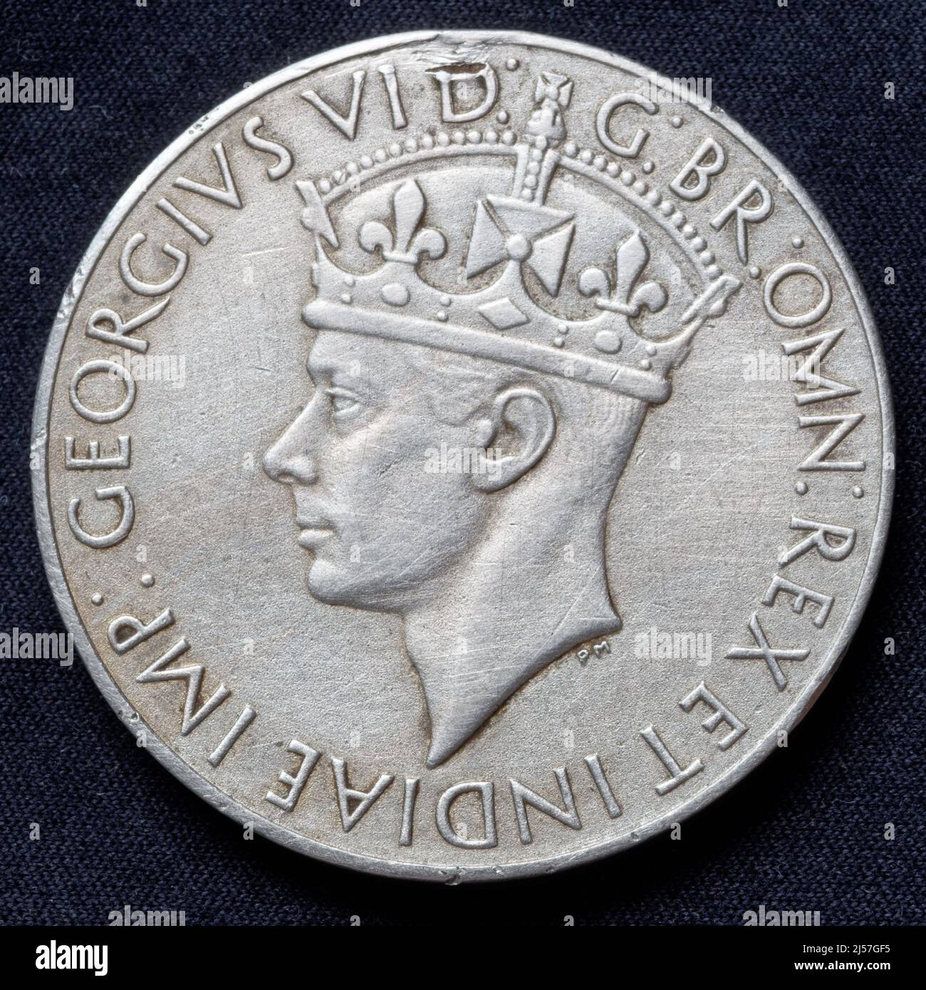 India: India Service Medal 1939 - 1945 (obverse), awarded to Indian Forces for at least 3 years of non-operational service in India between September 1938 and September 1945. This side shows King George VI, at the time titled King of Great Britain and Emperor of India. Stock Photo