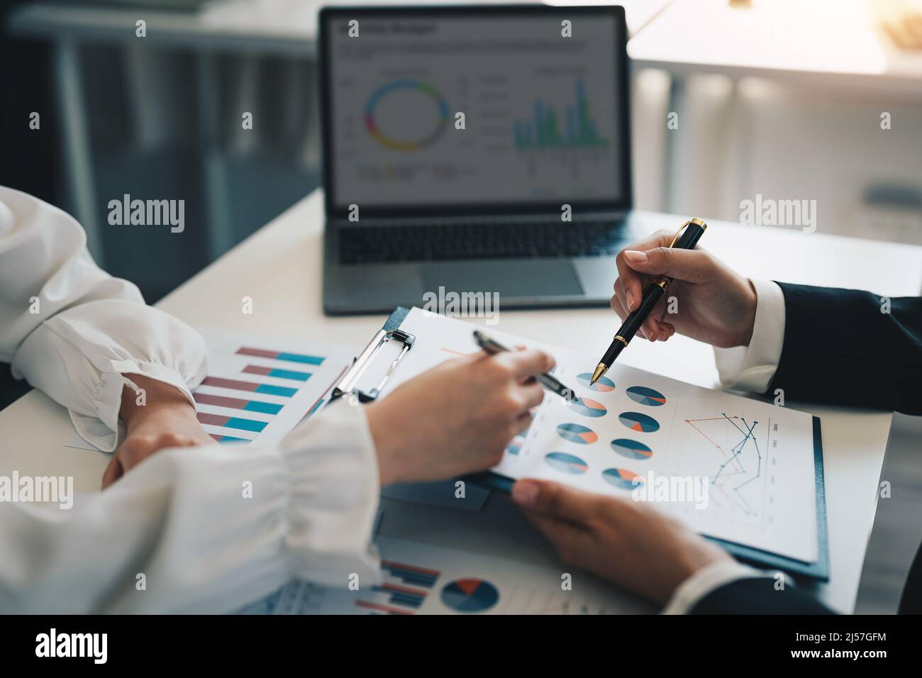 Business adviser analyzing financial figures denoting the progress in the work of the company, business and investment concept. Stock Photo