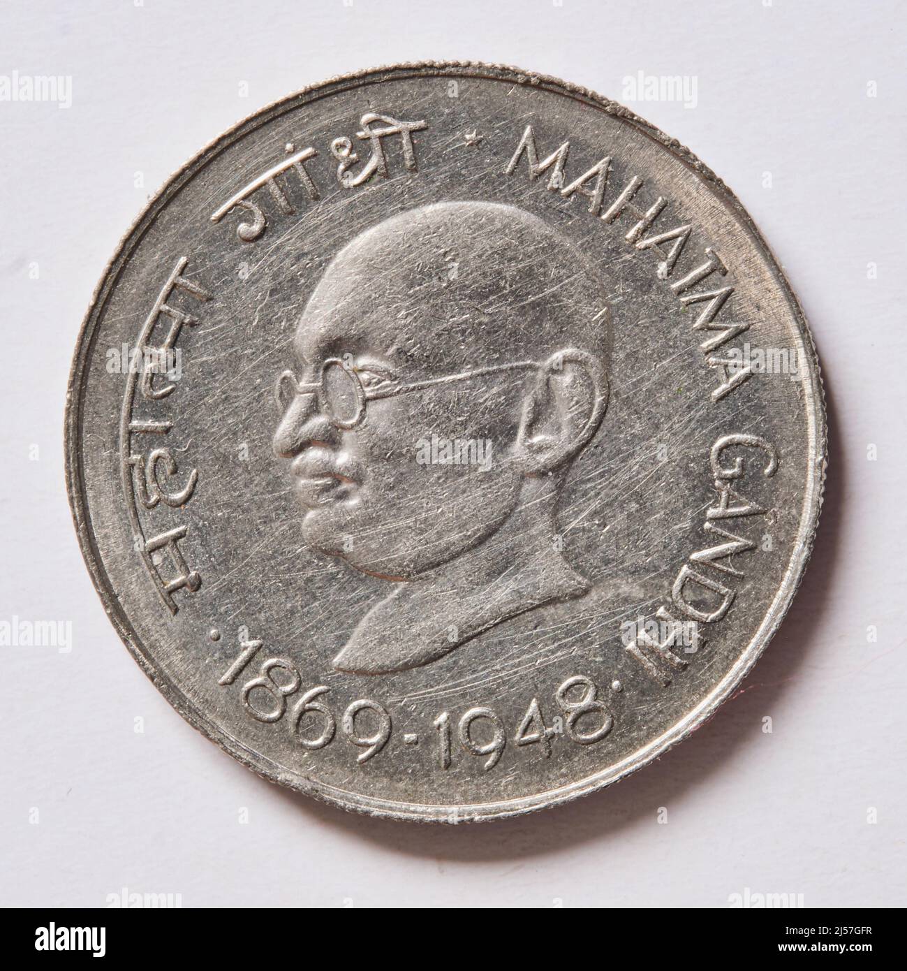 India: A 10 rupee coin commemorating the birth centenary of Mohandas Karamchand Gandhi (1869-1948) aka Mahatma Gandhi, 1969. Gandhi was the pre-eminent political and ideological leader of India during the Indian independence movement. He pioneered satyagraha. This is defined as resistance to tyranny through mass civil disobedience, a philosophy firmly founded upon ahimsa, or total non-violence. This concept helped India gain independence and inspired movements for civil rights and freedom across the world. Gandhi is often referred to as Mahatma Gandhi or 'Great Soul'. Stock Photo