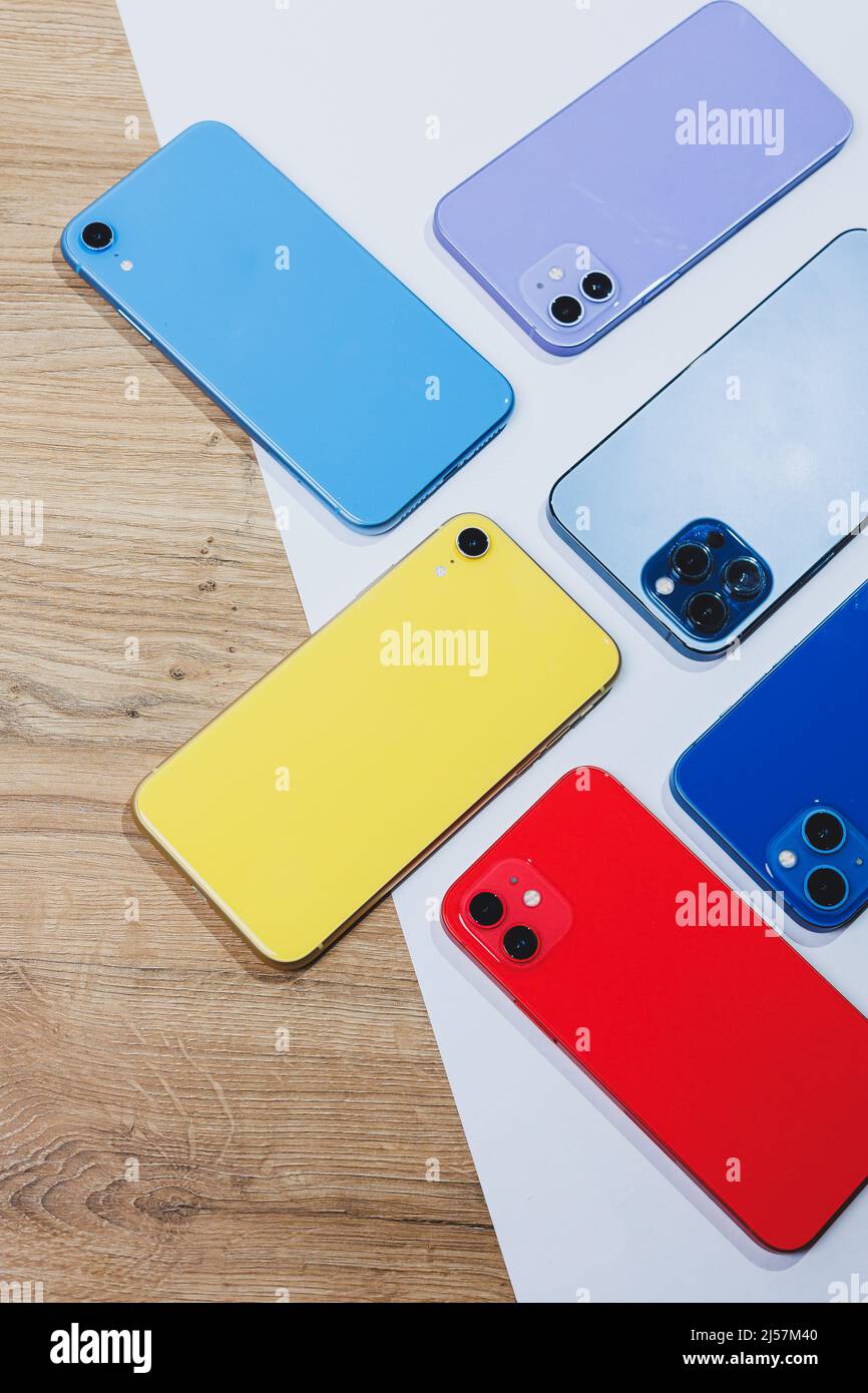 Arrangement with several multicolored modern telephones. Mobile phones