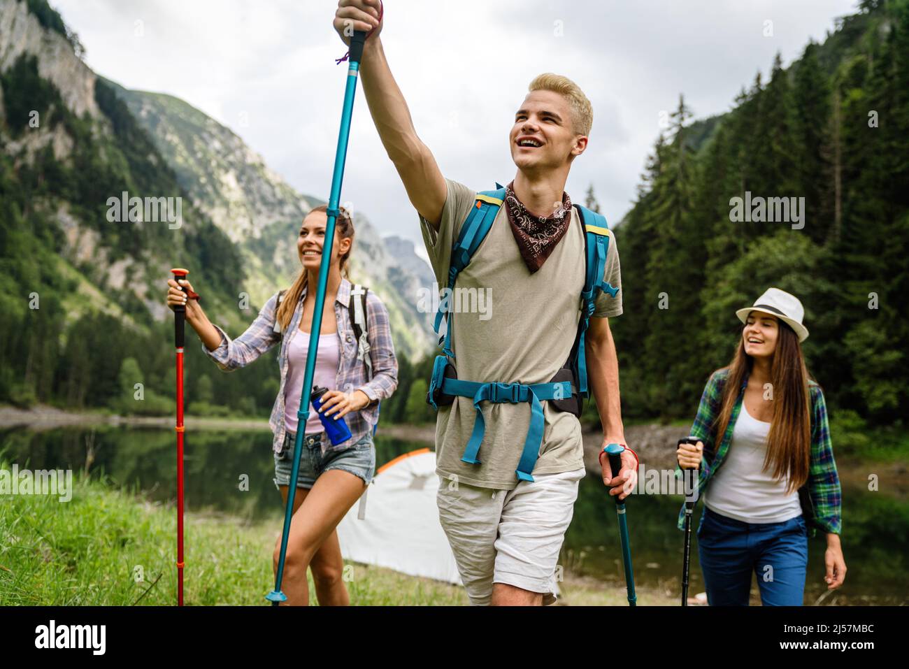 Group of young friends hiking in countryside. Multiracial happy people ...