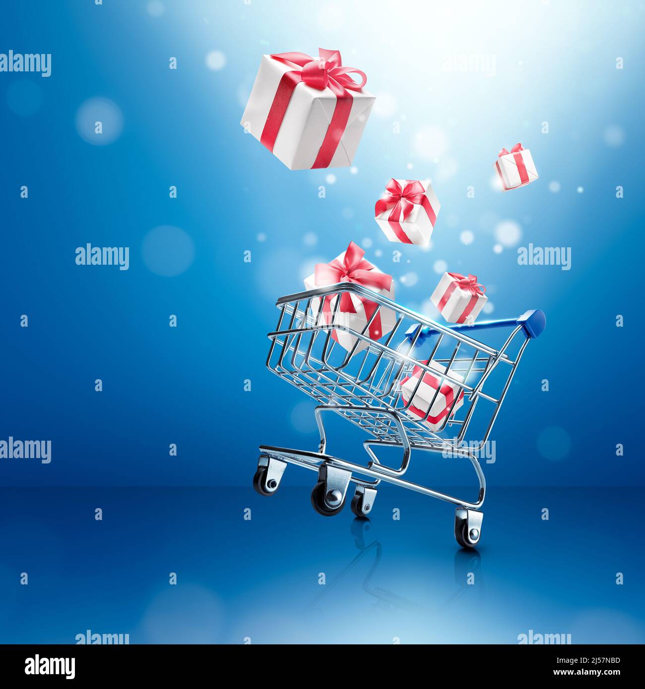 gift boxes pop out from wheelie shopping cart over blue background Stock Photo