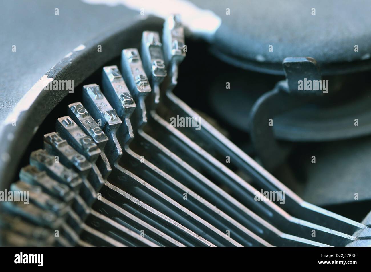 Close-up horizontal shot of metal printing letters using on a typewriters. Stock Photo